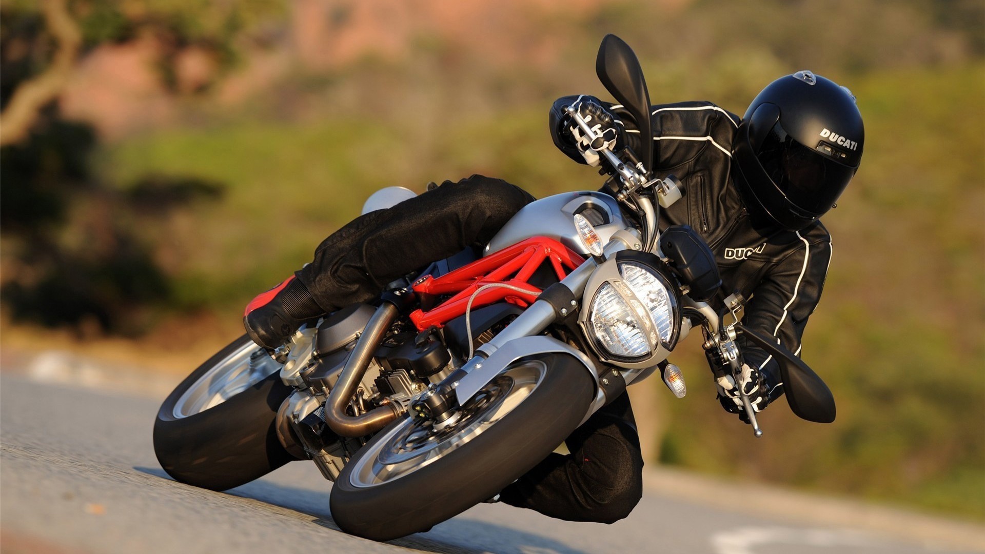 Ducati motorcycle rider on a road HD Wallpaper