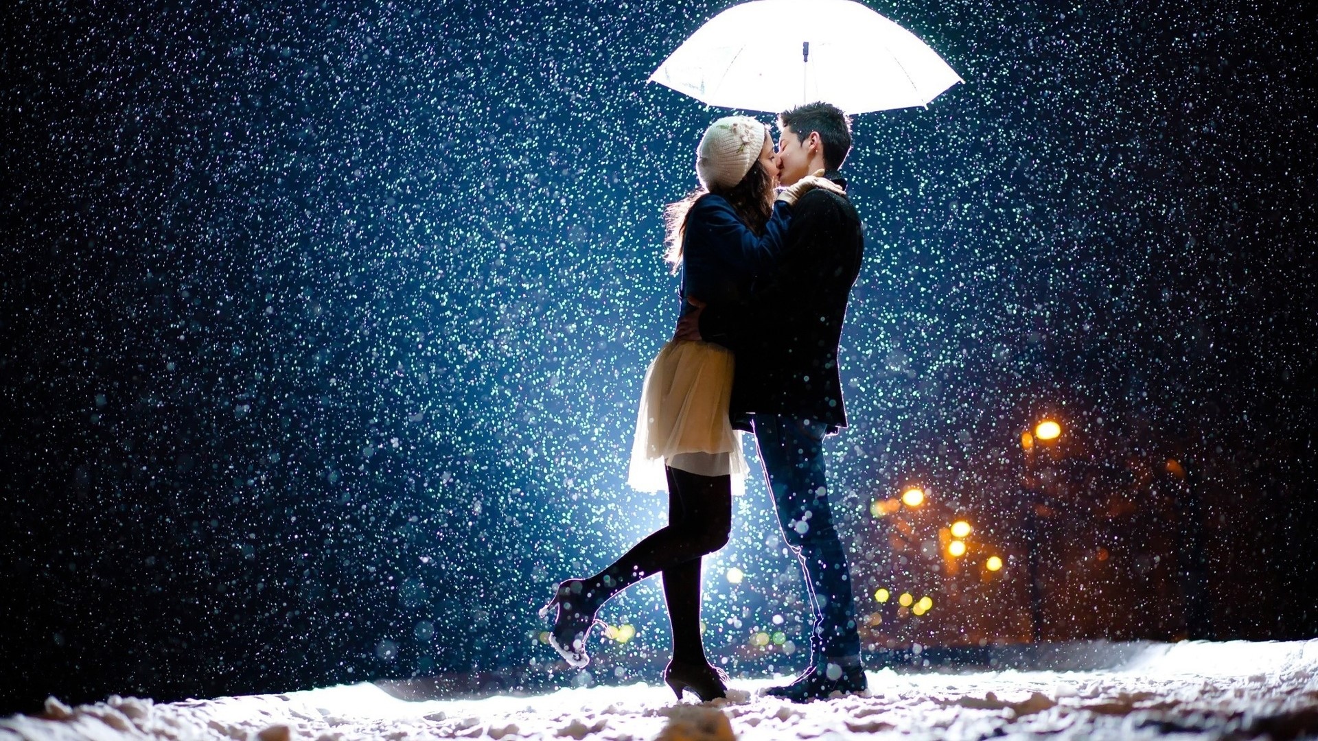Couple kissing under umbrella in snow HD Wallpaper