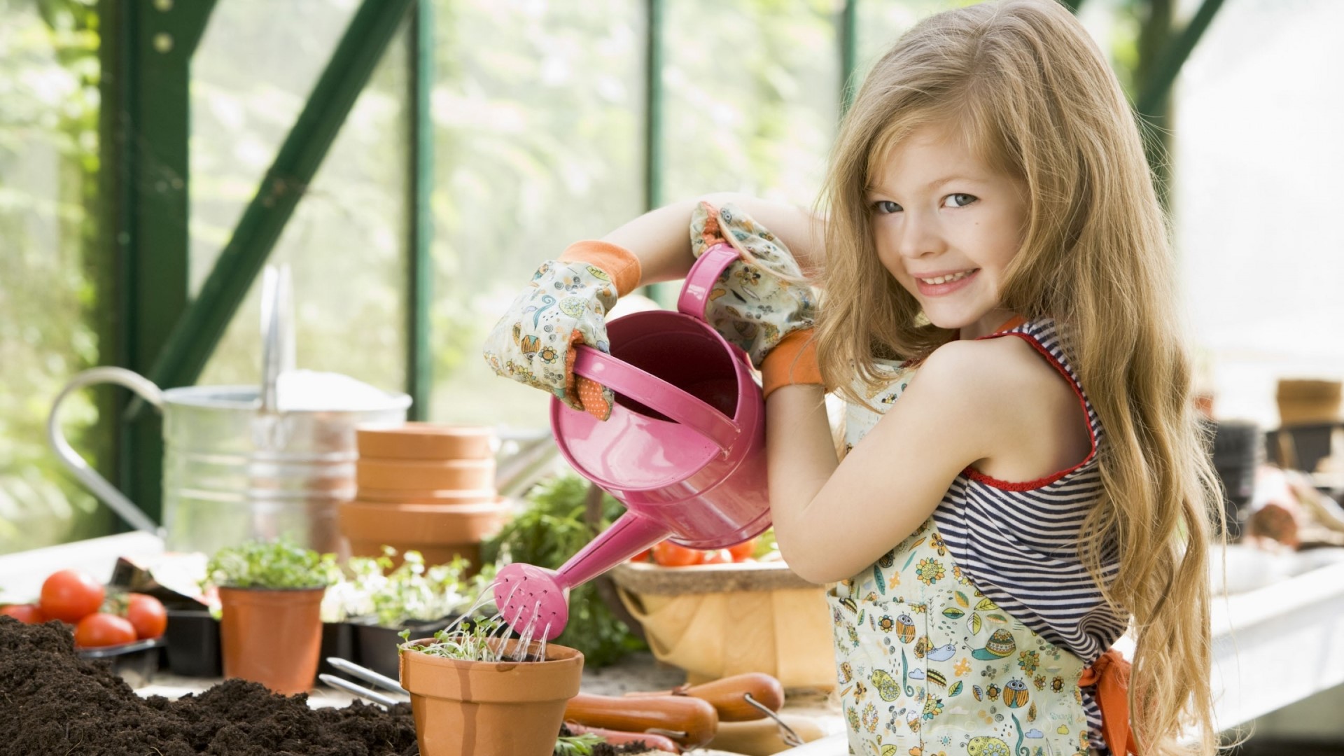 Girl watering plants in a greenhouse HD Wallpaper