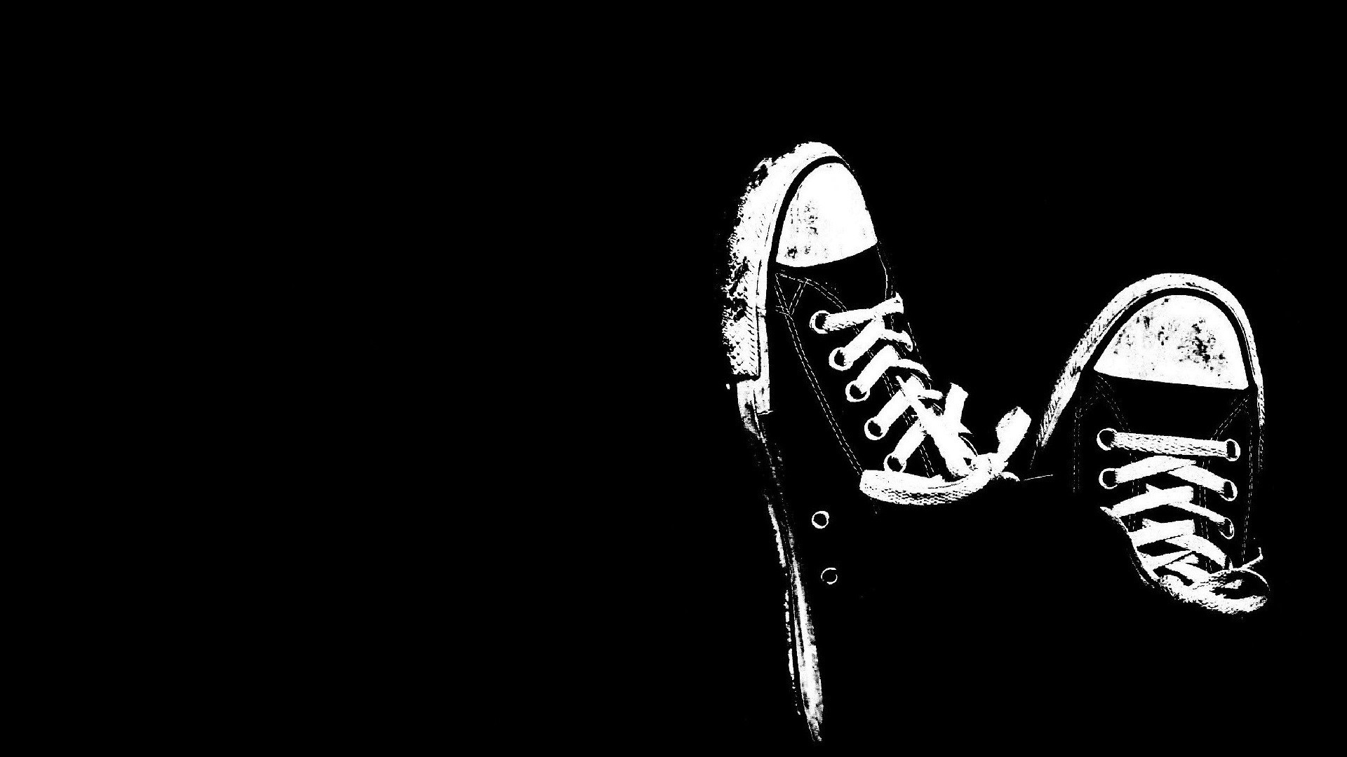 Black Converse shoes on black background HD Wallpaper