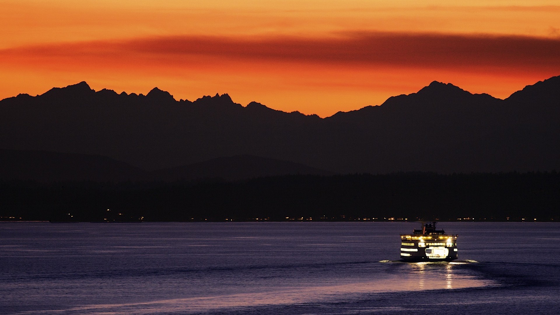 Ferry on water at sunset with mountains HD Wallpaper