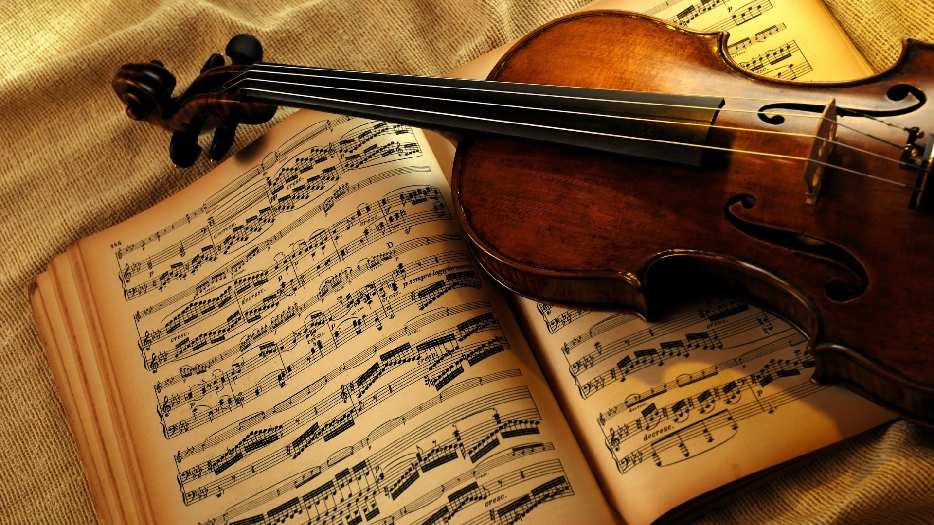 Violin resting on sheet music HD Wallpaper