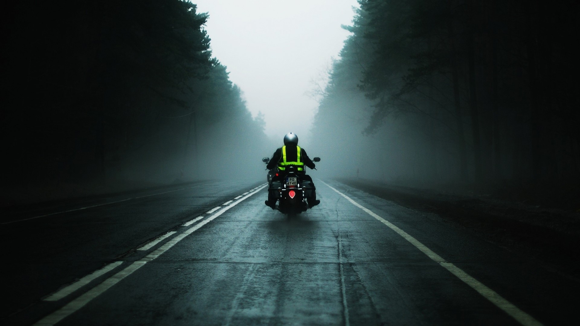 Motorcyclist on a foggy road HD Wallpaper