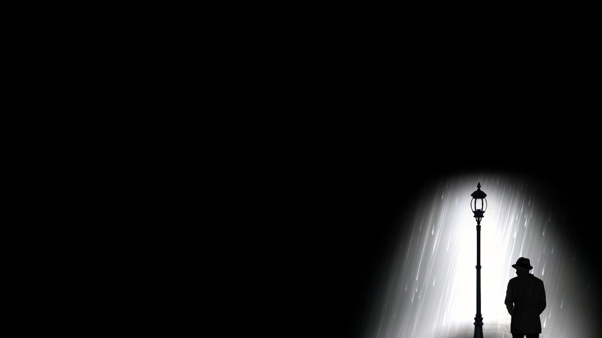 Silhouette of a man under a streetlight in the rain HD Wallpaper