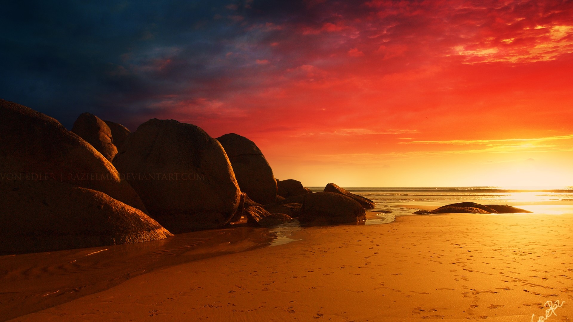 Beach with large rocks during a fiery sunset HD Wallpaper