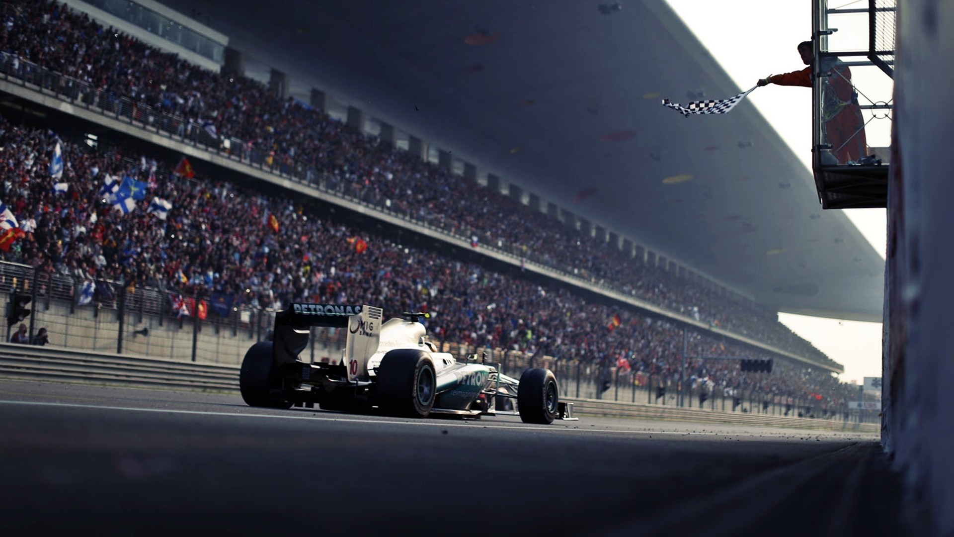 Formula 1 Race Car Crossing Finish Line with Chequered Flag HD Wallpaper