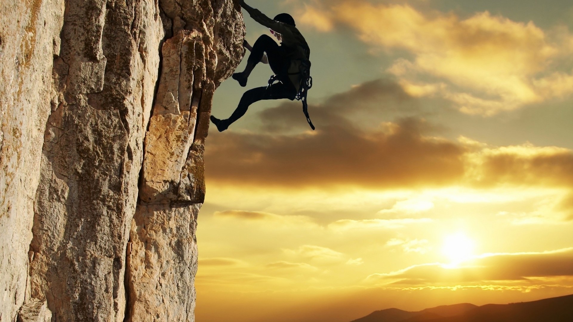 Silhouette of a rock climber at sunset HD Wallpaper