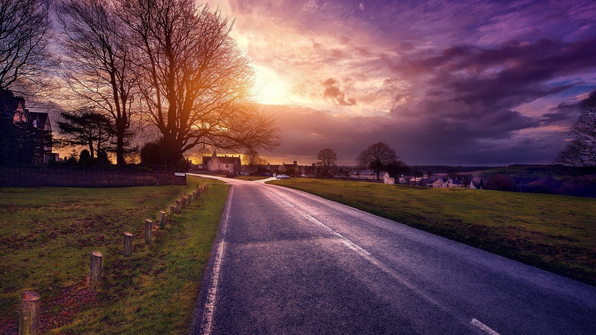 Road leading to village at sunset HD Wallpaper