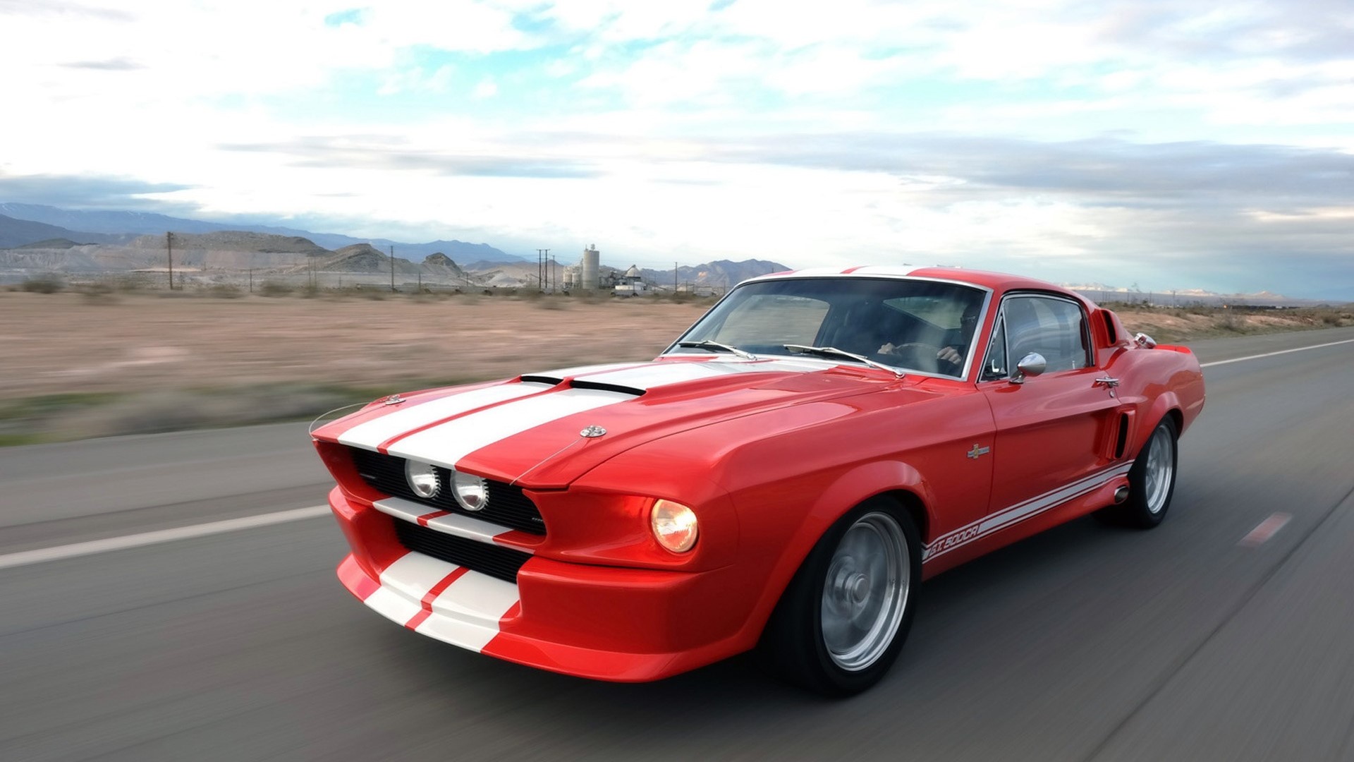 Red Shelby GT500 driving on a desert road HD Wallpaper