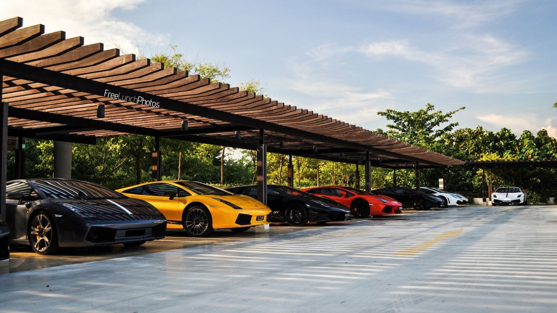 Lamborghinis parked under a wooden pergola HD Wallpaper