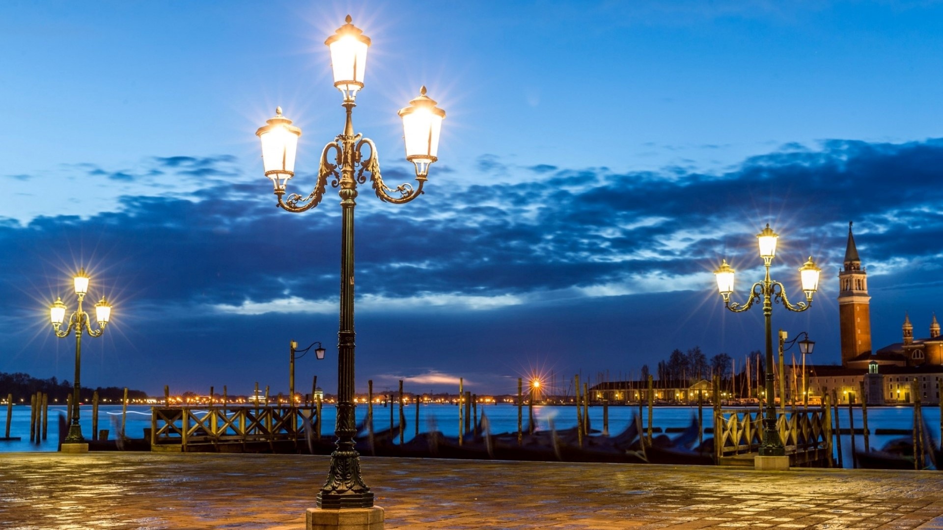 Venice waterfront with gondolas and streetlights at dusk HD Wallpaper