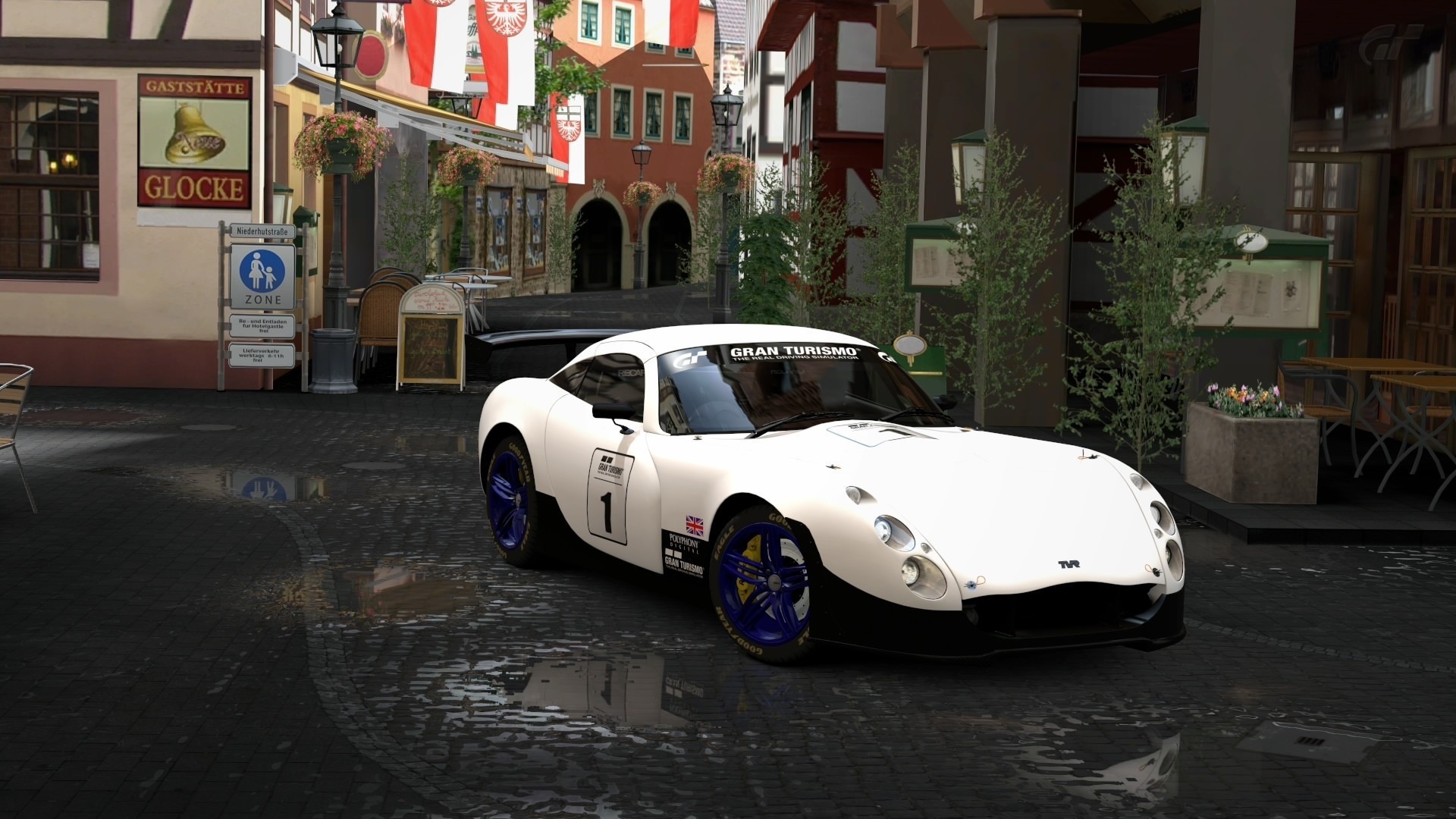 White TVR Gran Turismo 5 race car on wet cobblestone street HD Wallpaper