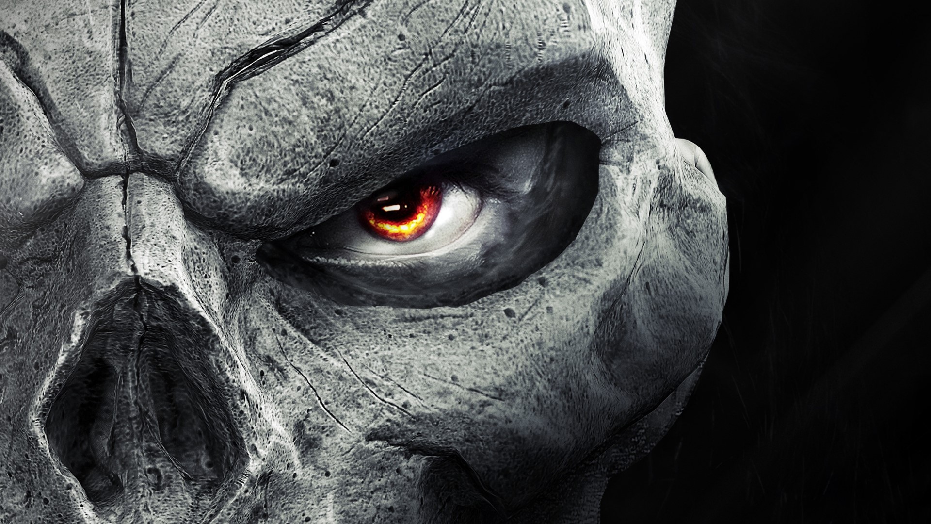 Close-up of a stone skull with a glowing red eye HD Wallpaper