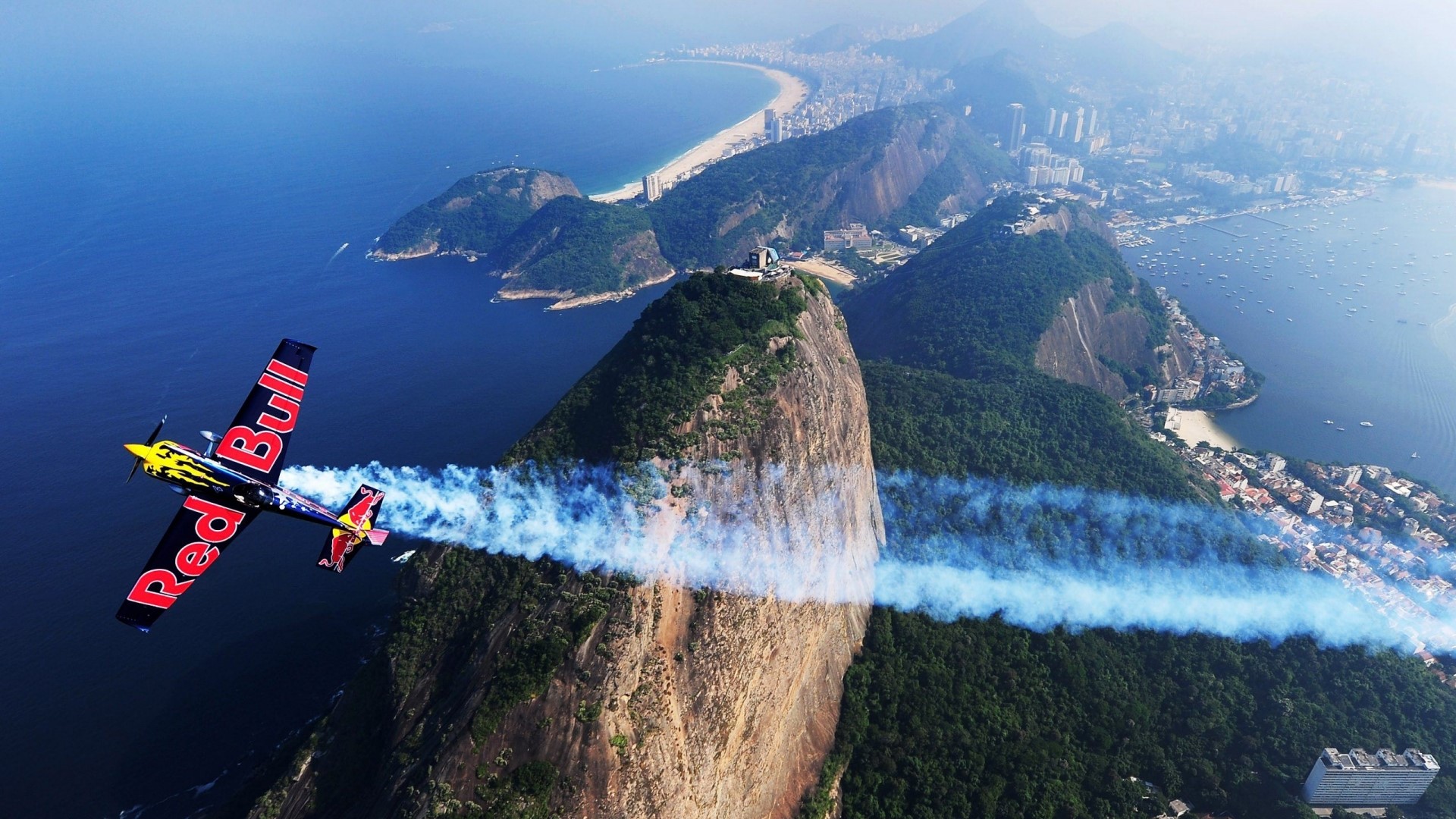 Red Bull stunt plane flying over Rio de Janeiro HD Wallpaper