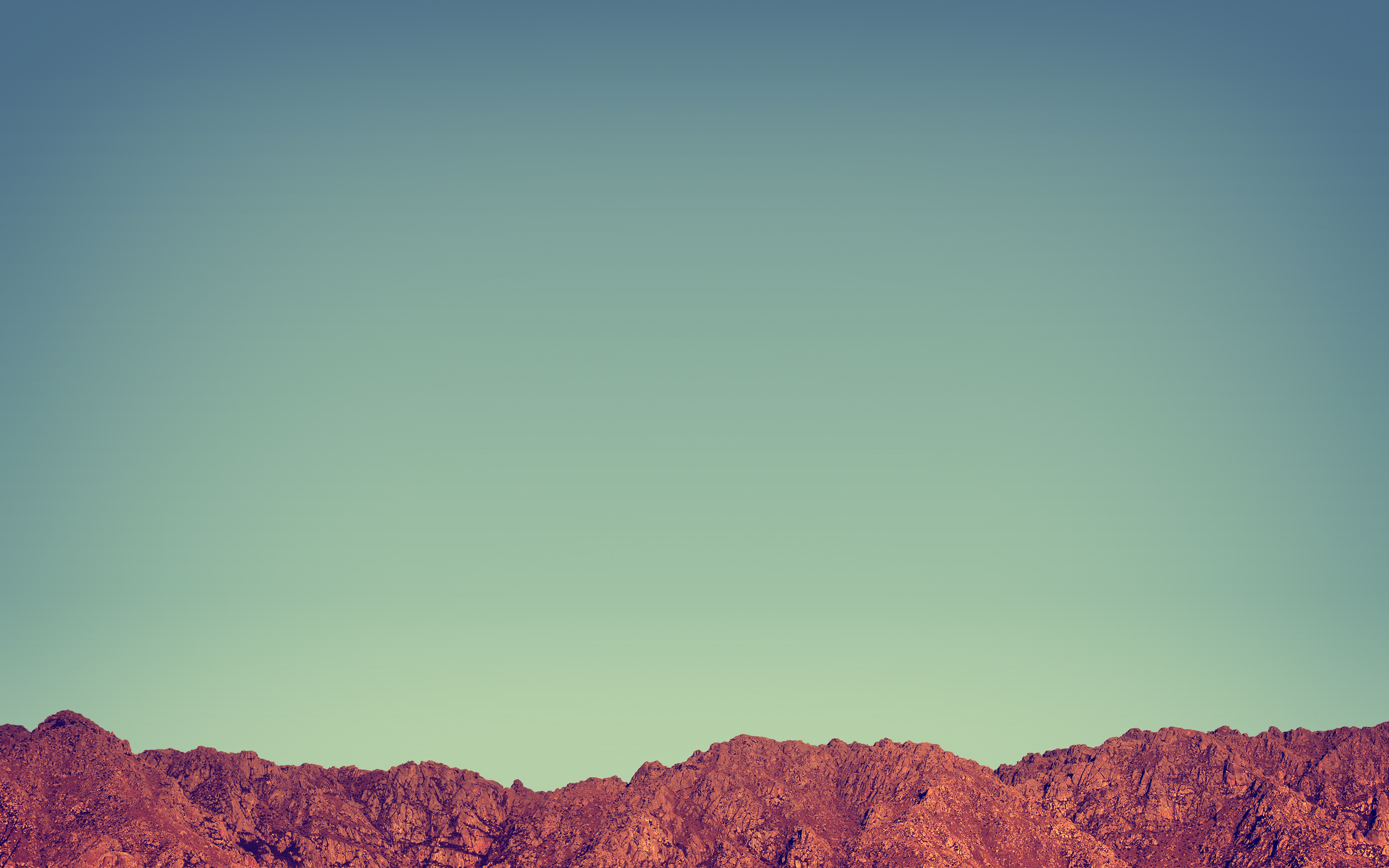 Rocky mountain range under a clear sky HD Wallpaper