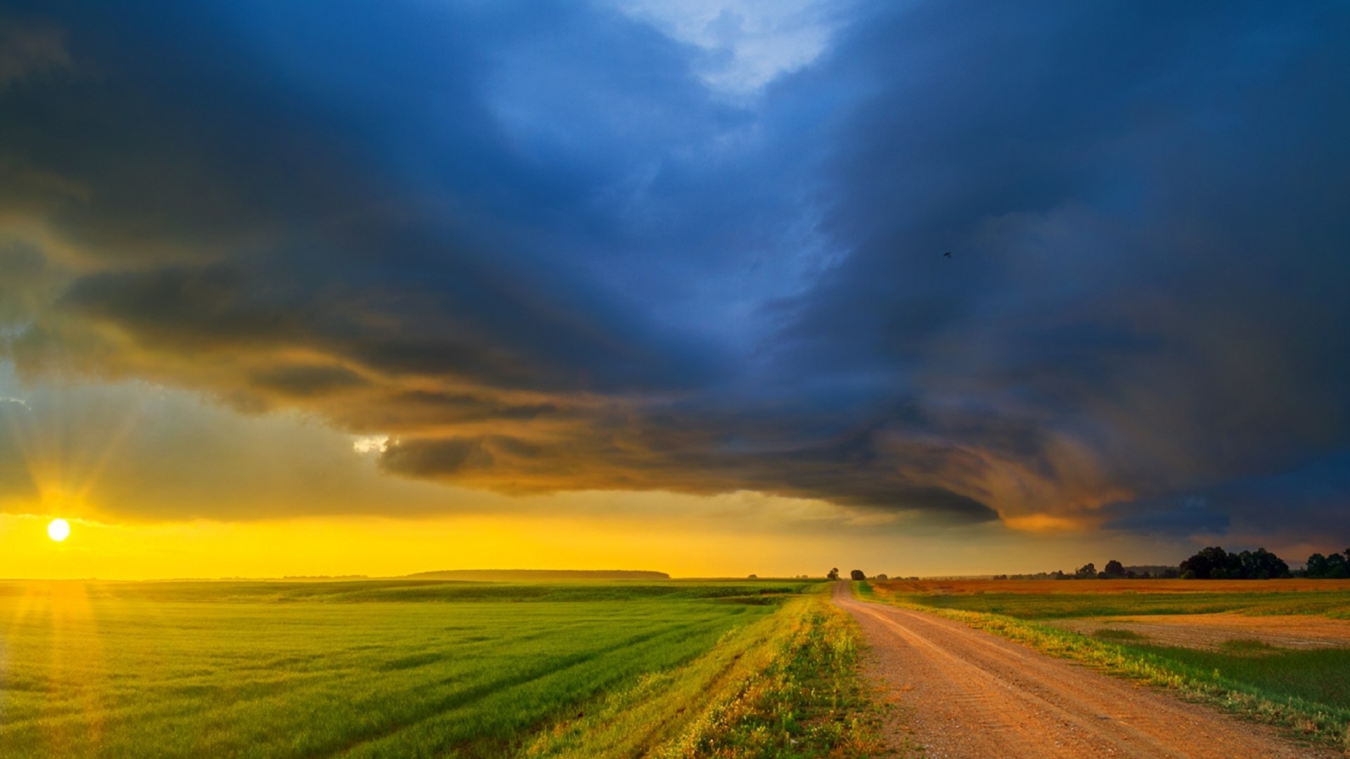 Country road at sunset with storm clouds HD Wallpaper