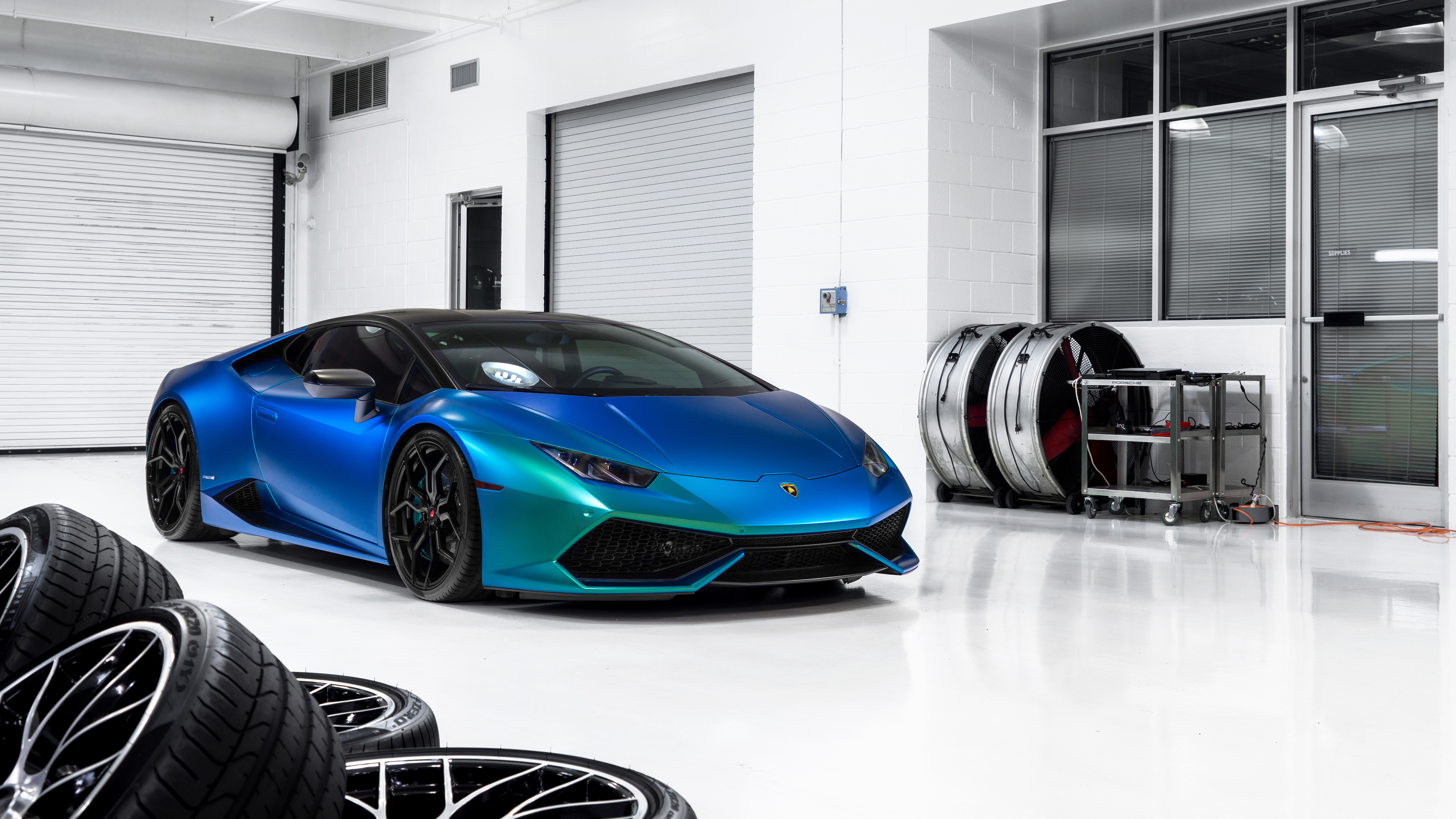 Lamborghini Huracan in a garage with tires HD Wallpaper