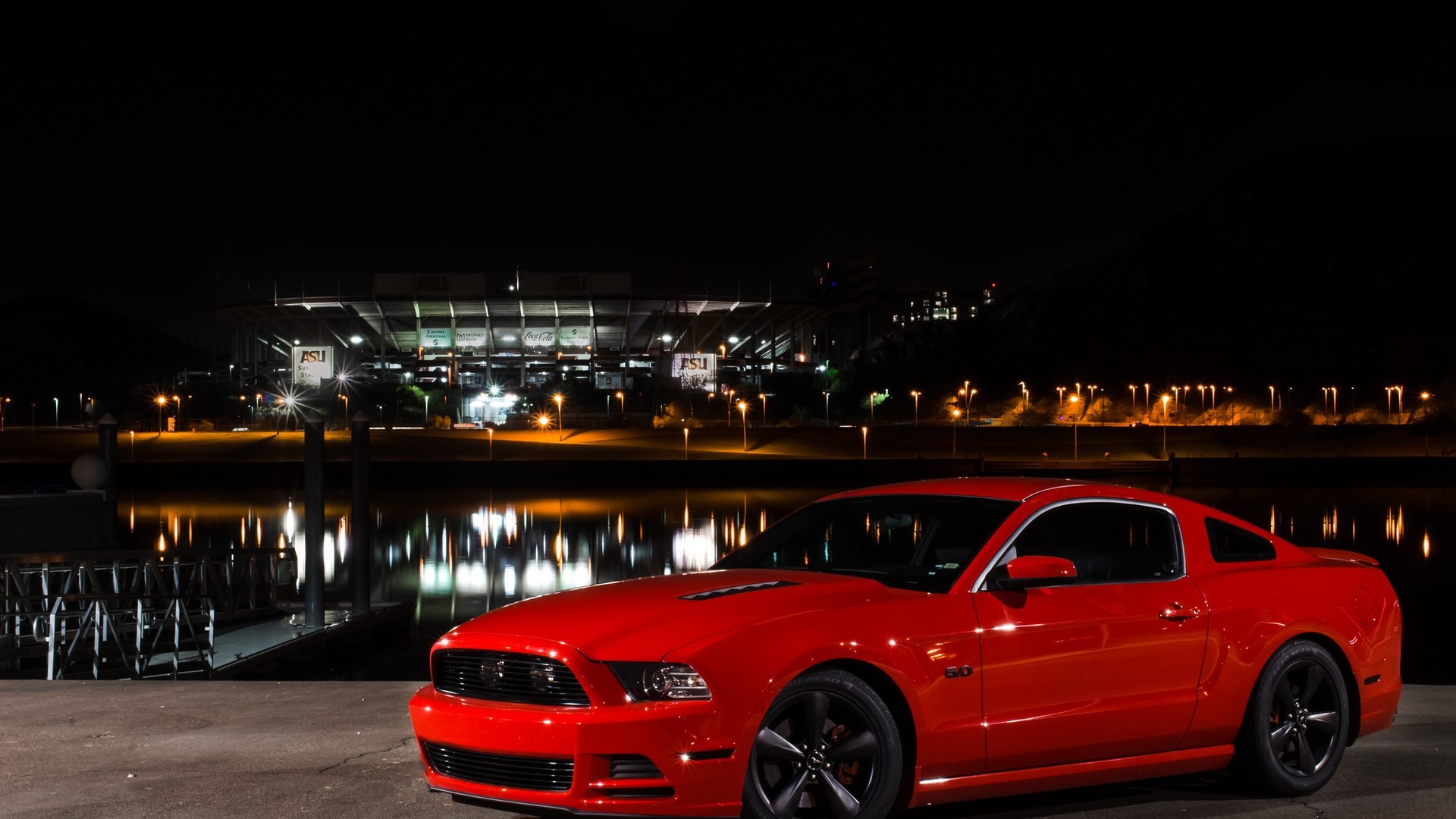 Red Ford Mustang parked by a stadium at night HD Wallpaper