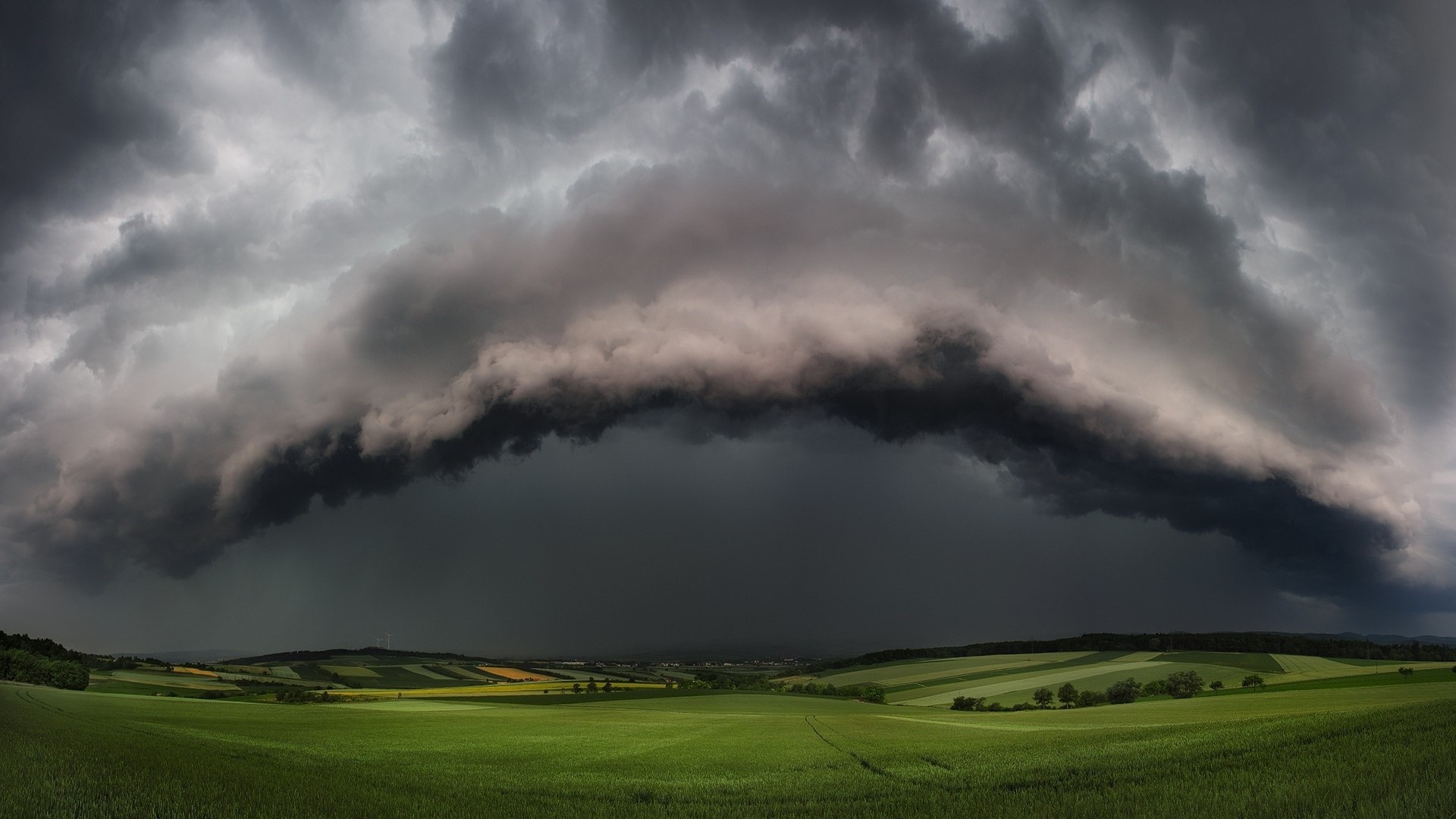 Storm clouds over green fields HD Wallpaper