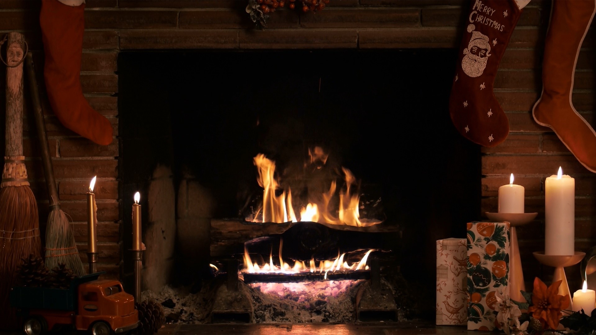 Christmas fireplace with stockings and candles HD Wallpaper