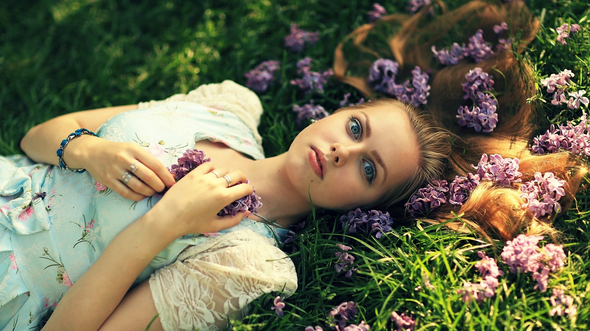 Girl lying in grass with flowers HD Wallpaper