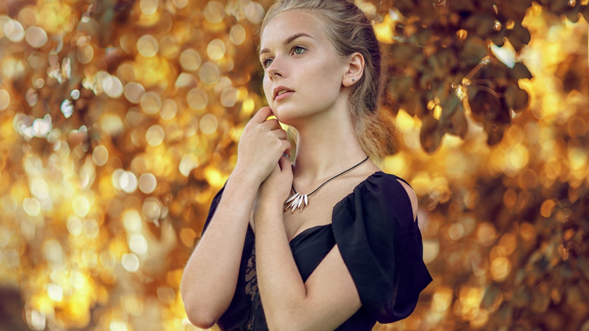 Young woman with blonde hair and a black dress HD Wallpaper