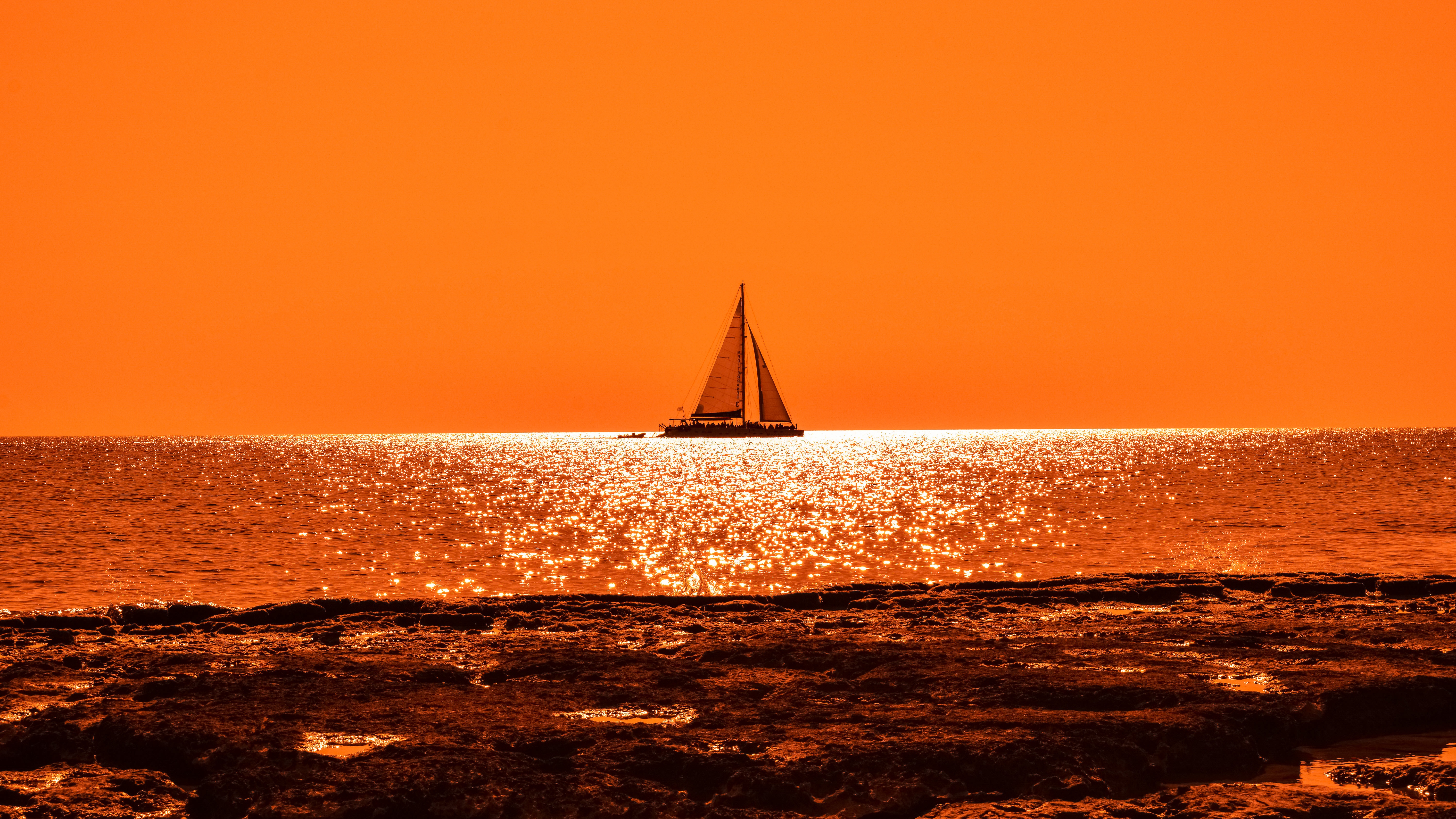 Sailboat on the ocean at sunset HD Wallpaper