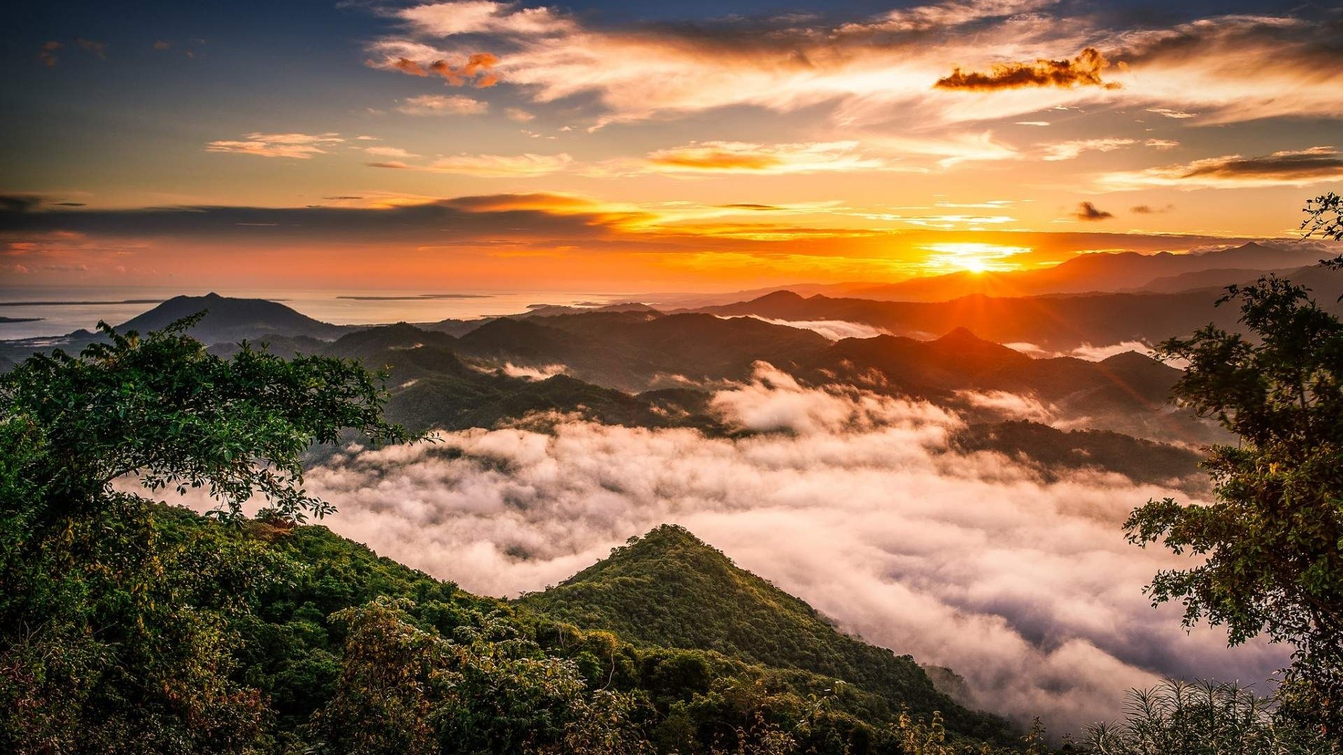 Sunset over misty mountains and ocean HD Wallpaper