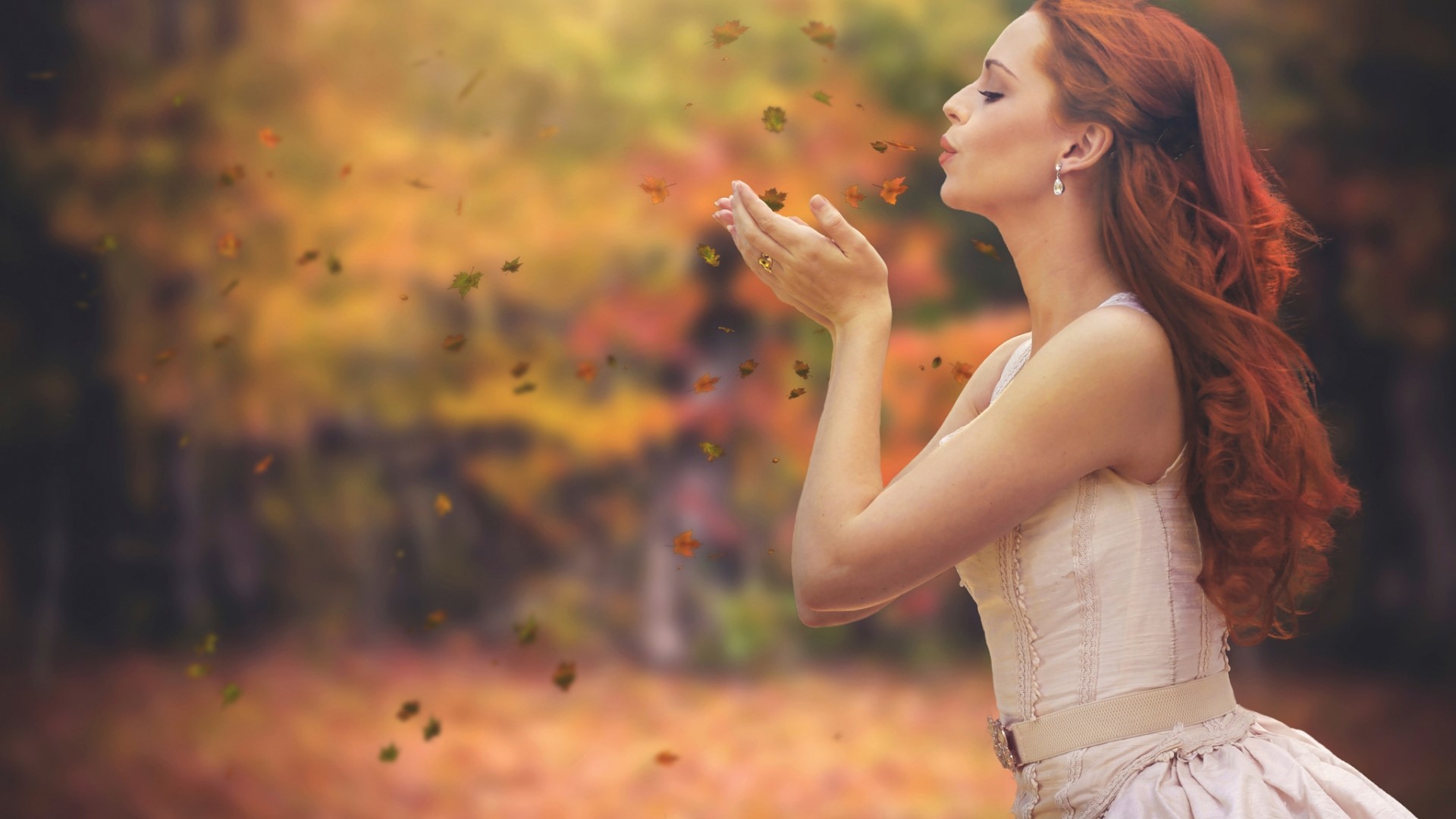Woman blowing leaves in autumn forest HD Wallpaper