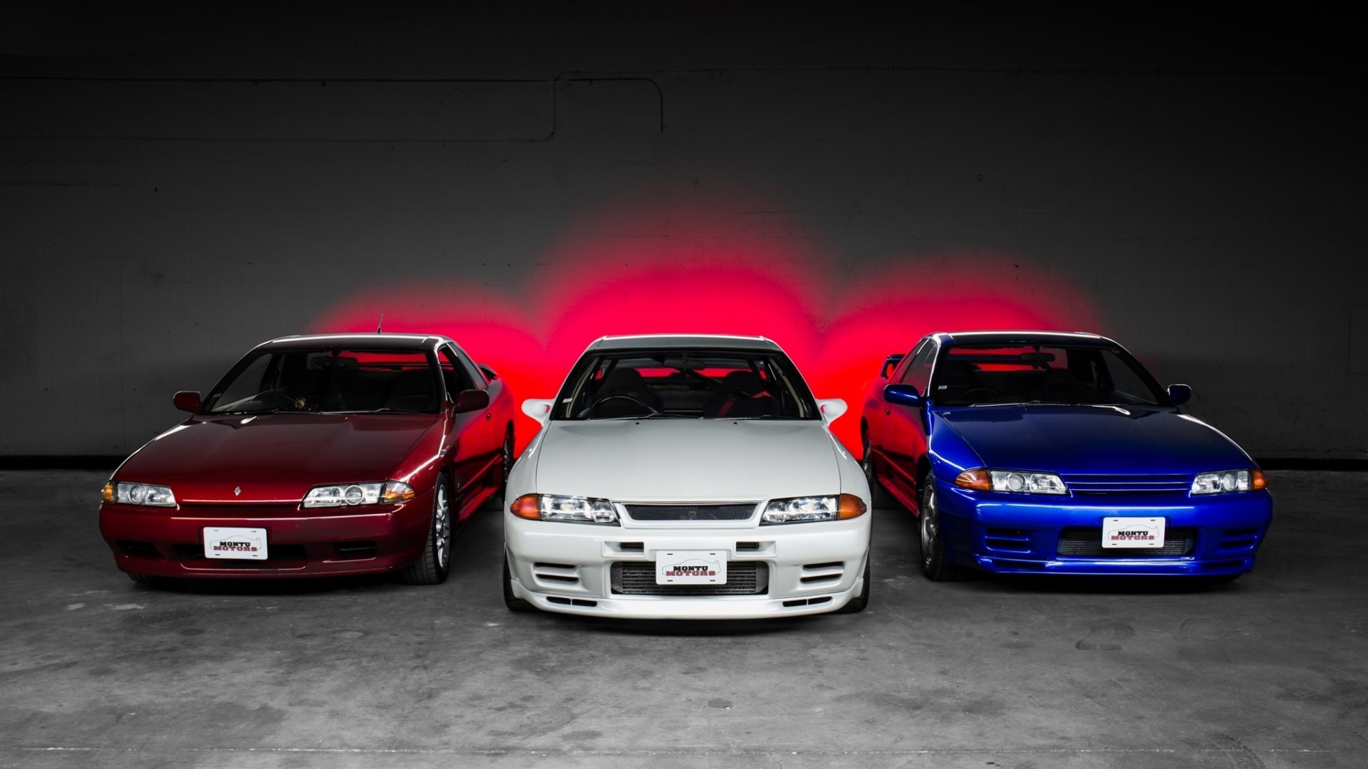 Three Nissan Skyline R32 cars in a studio HD Wallpaper