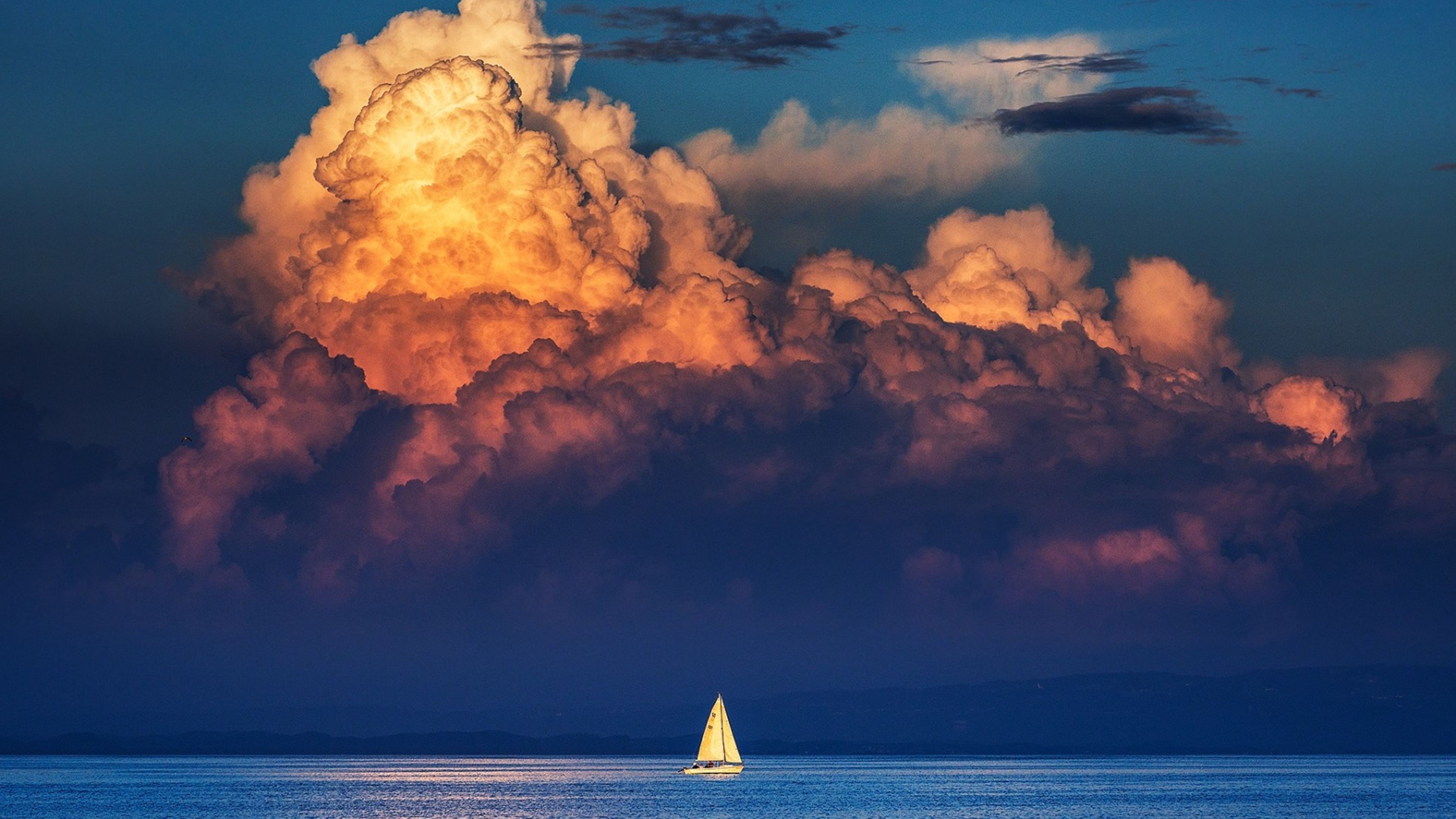 Sailboat on the sea with dramatic clouds HD Wallpaper