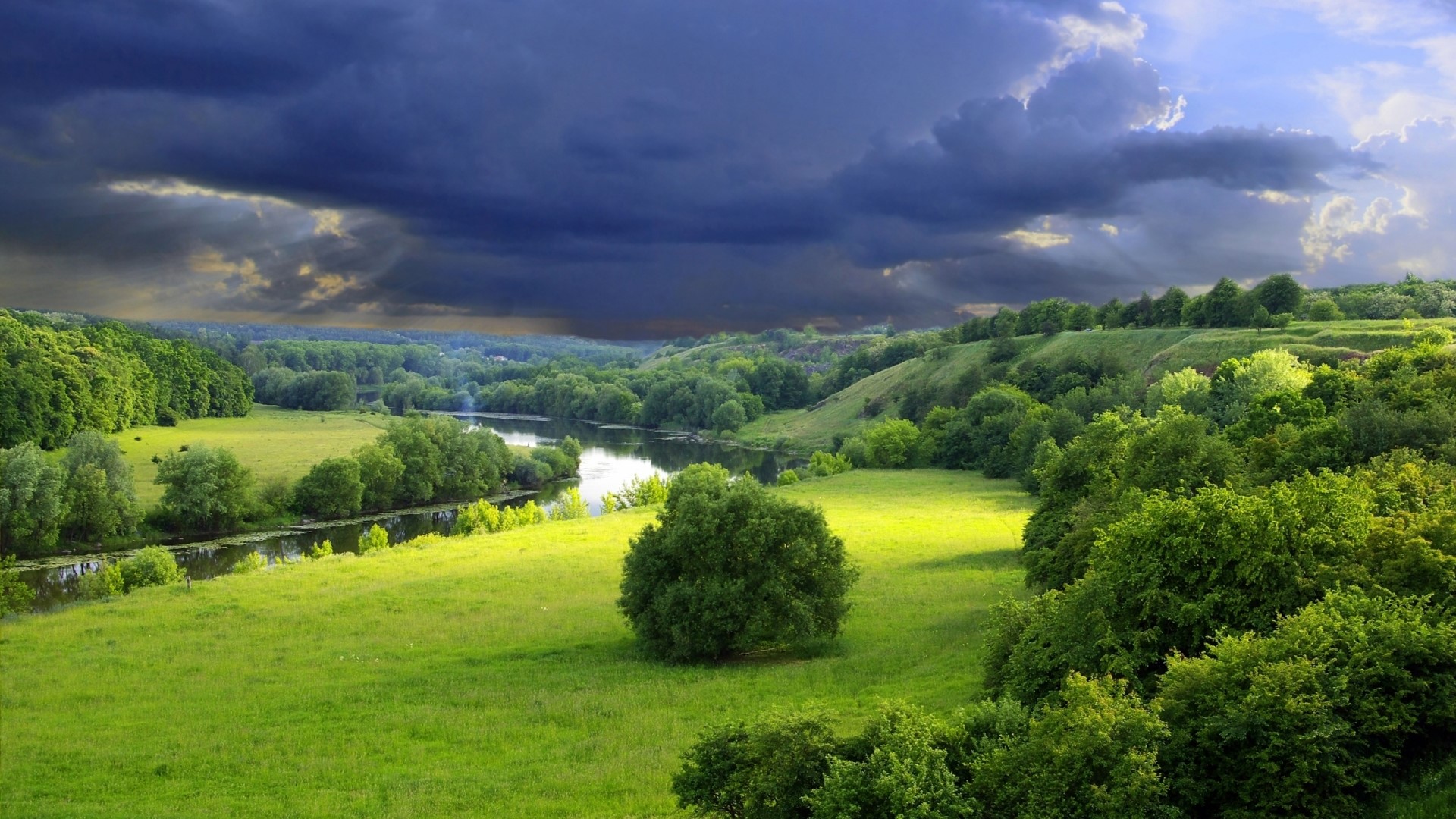 Green valley with river and stormy sky HD Wallpaper
