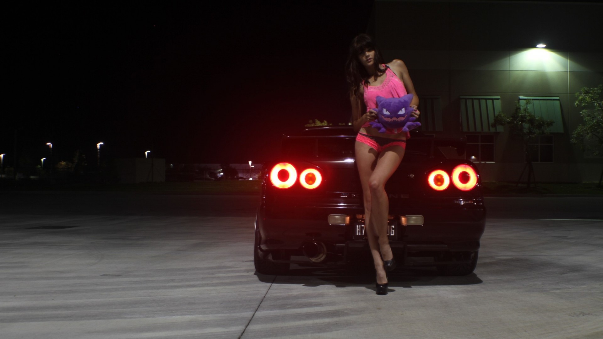 Woman with Pokemon plush by Nissan car at night HD Wallpaper
