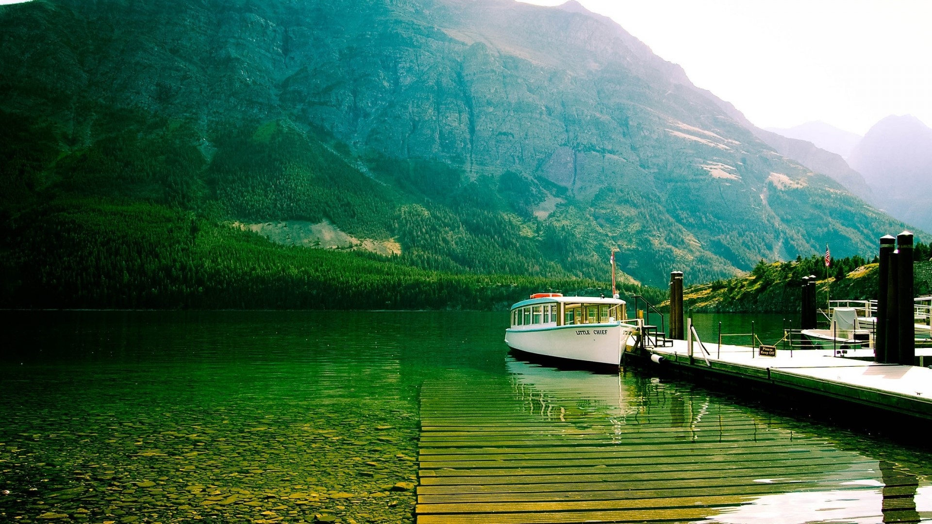Boat docked on a mountain lake HD Wallpaper
