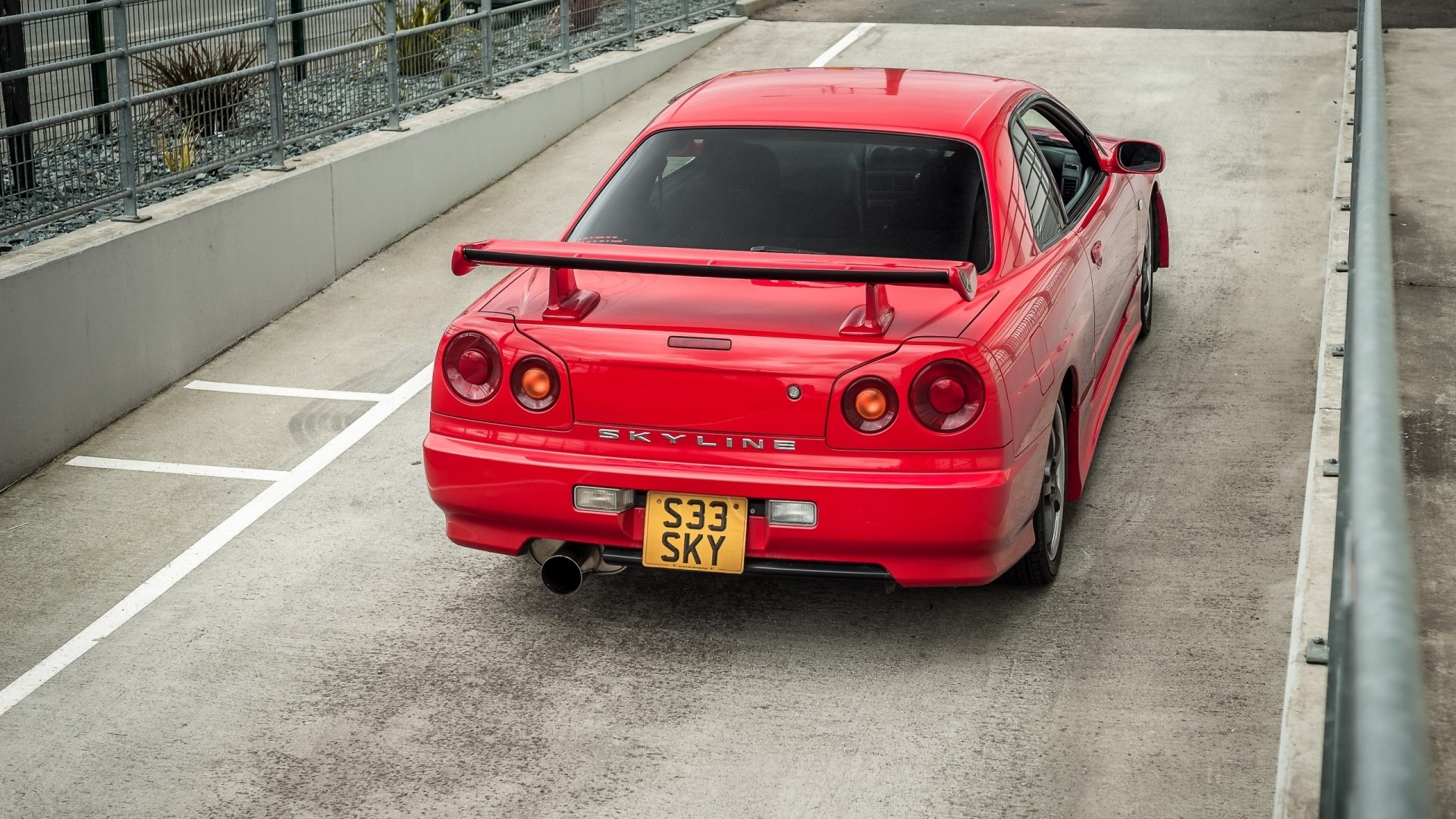 Red Nissan Skyline R34 rear view HD Wallpaper