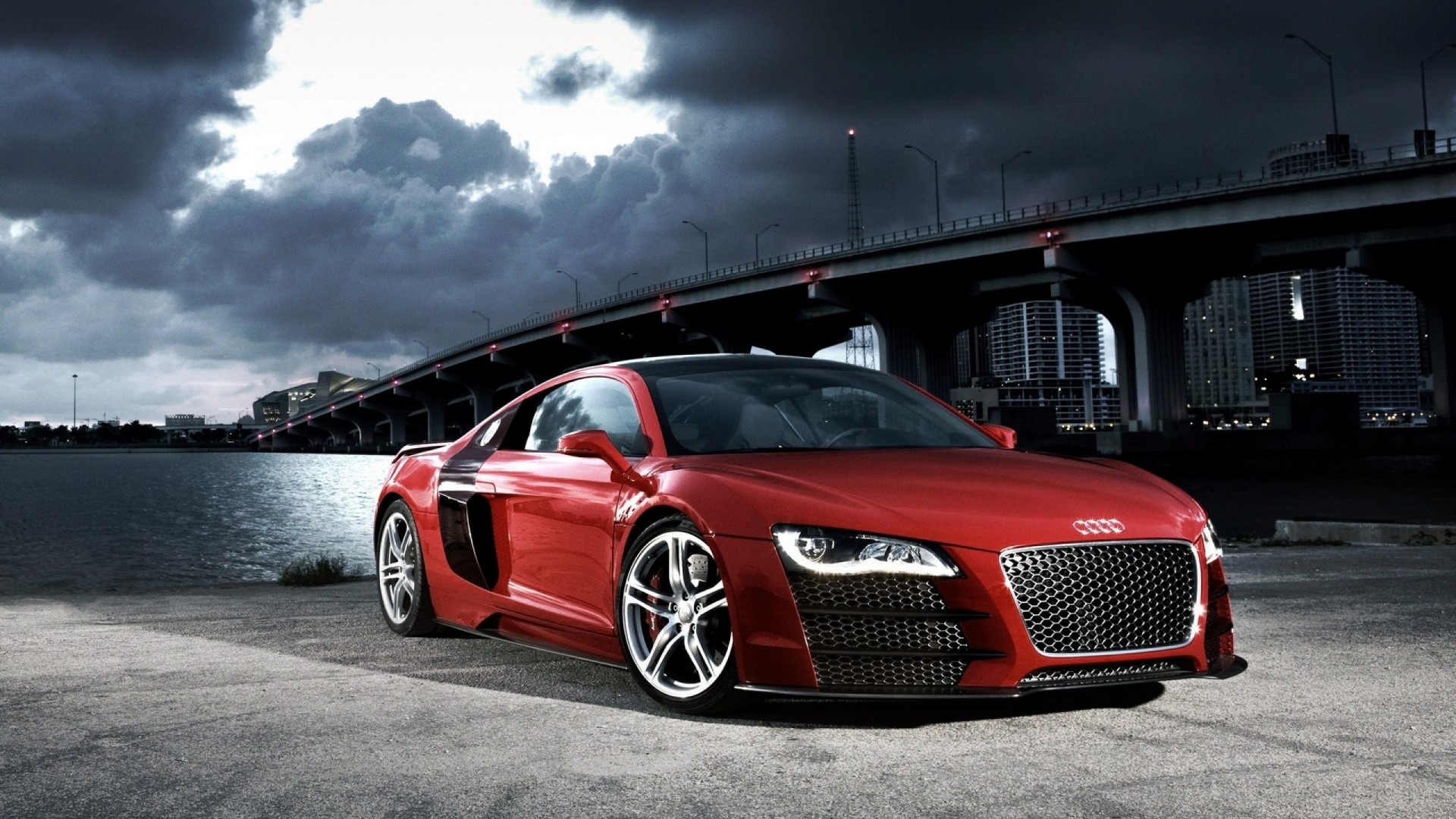 Red Audi R8 parked by a bridge and city HD Wallpaper