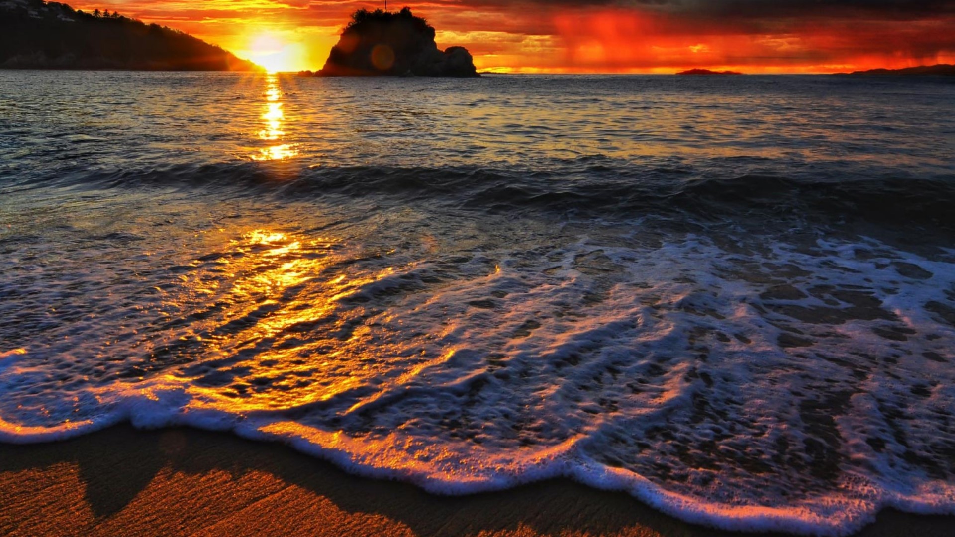 Sunset over the ocean with a rocky island HD Wallpaper