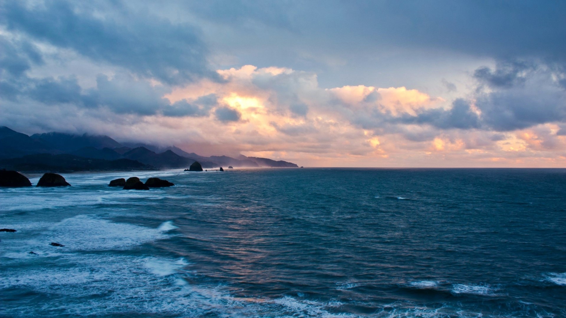 Cloudy Sunset Over the Sea with Coastal Mountains HD Wallpaper
