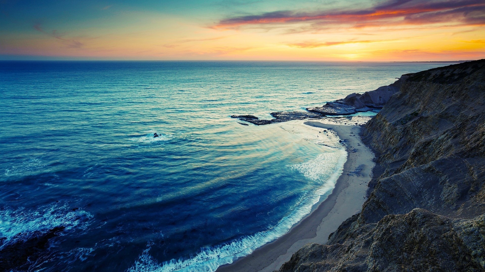 Coastline at sunset with ocean waves HD Wallpaper