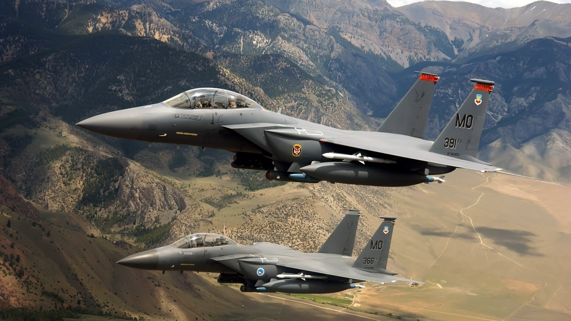 Two F-15 Eagles flying over mountains HD Wallpaper
