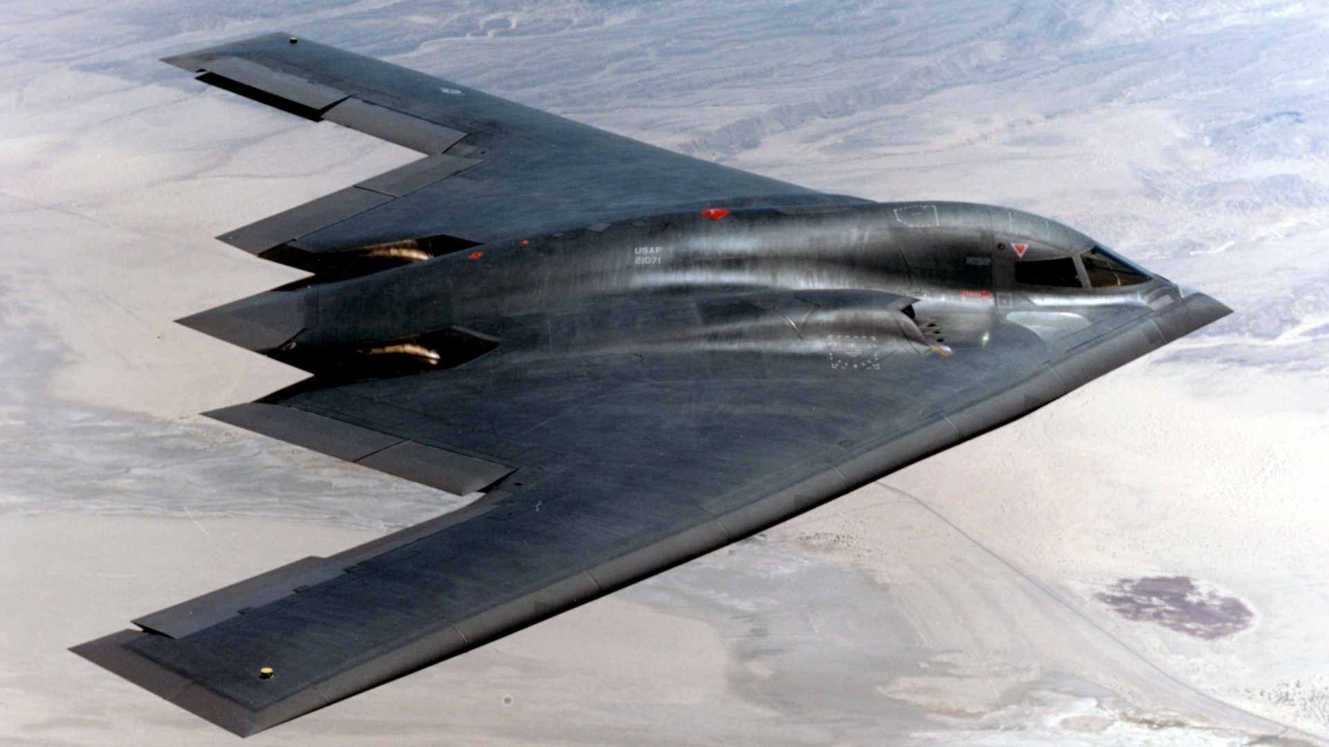 B-2 Spirit Bomber flying over desert HD Wallpaper