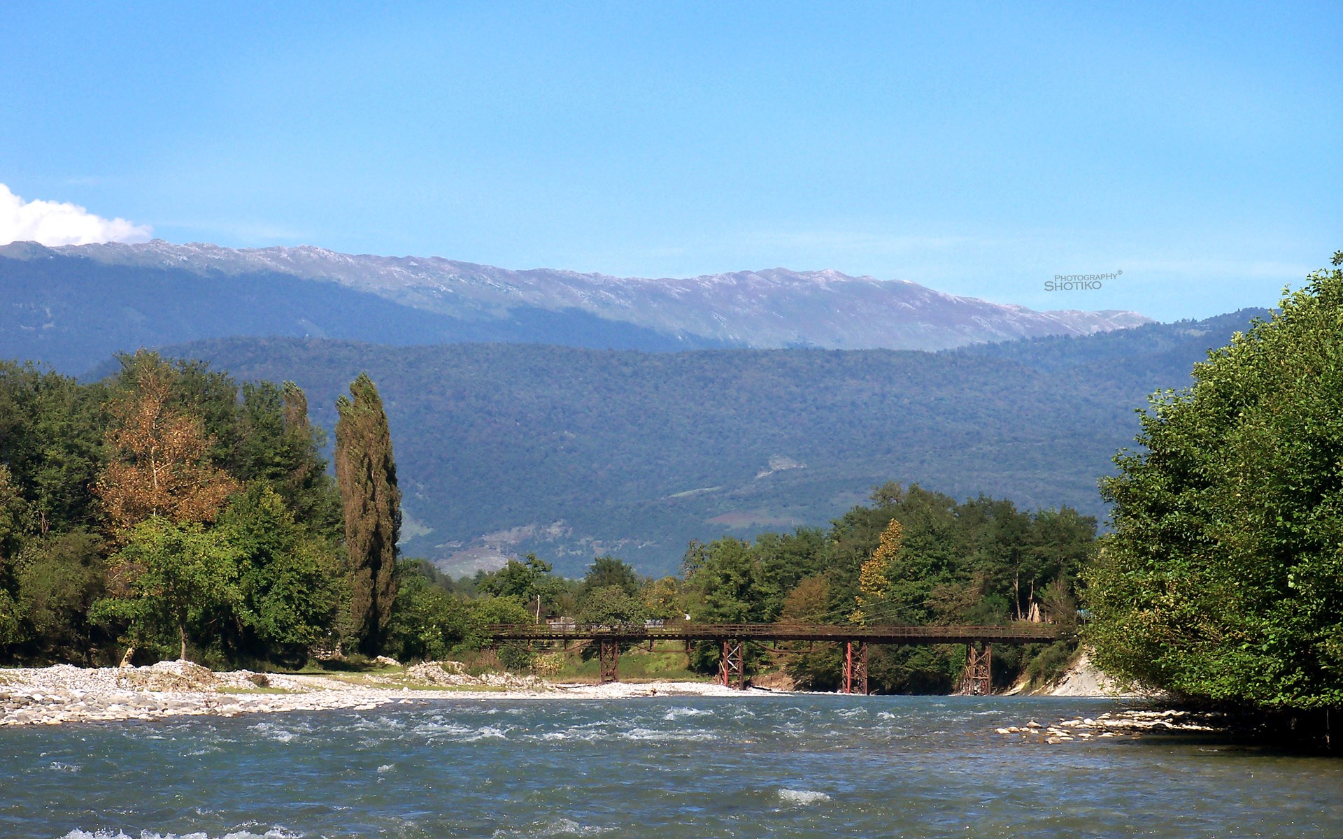 River and bridge with mountains in the background HD Wallpaper