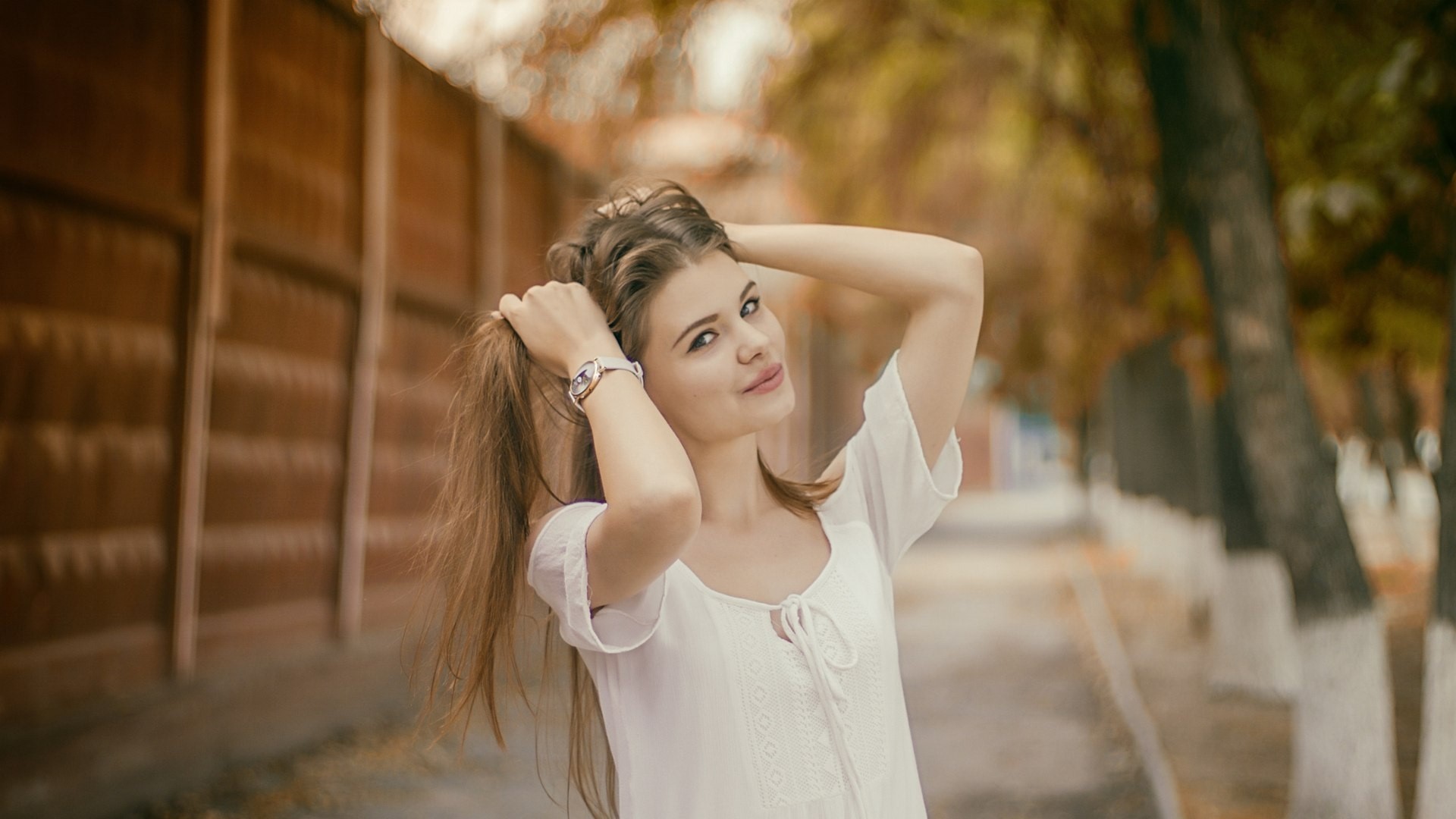 Young woman with long brown hair outdoors HD Wallpaper