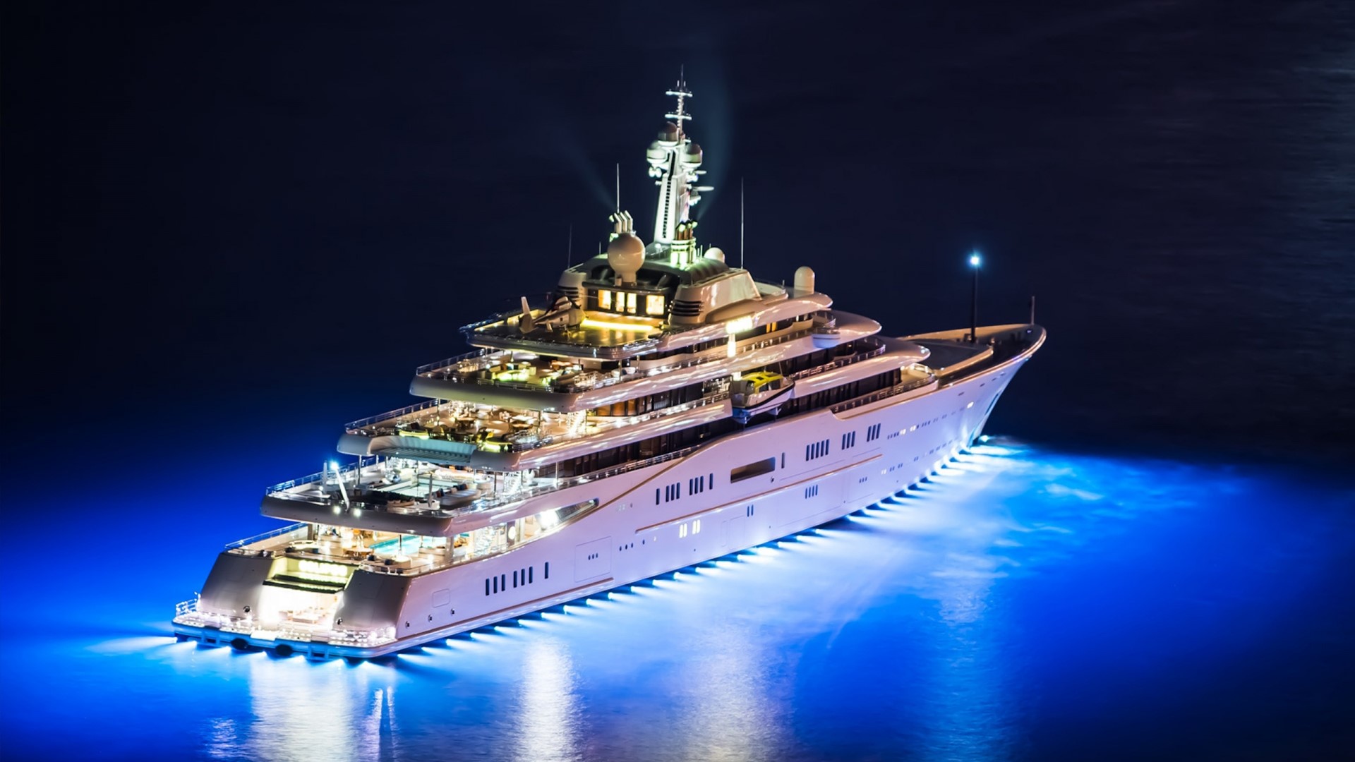 Luxury yacht illuminated at night HD Wallpaper