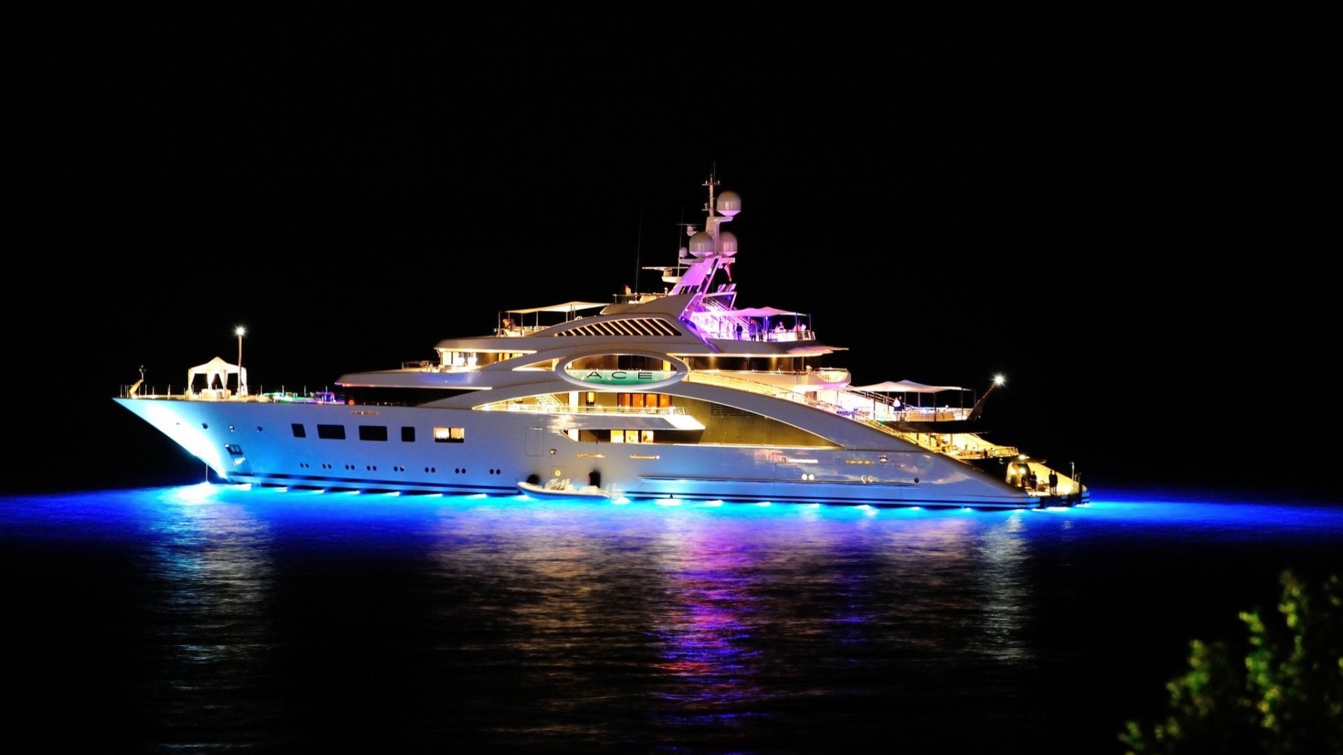 The ACE Yacht illuminated at night HD Wallpaper