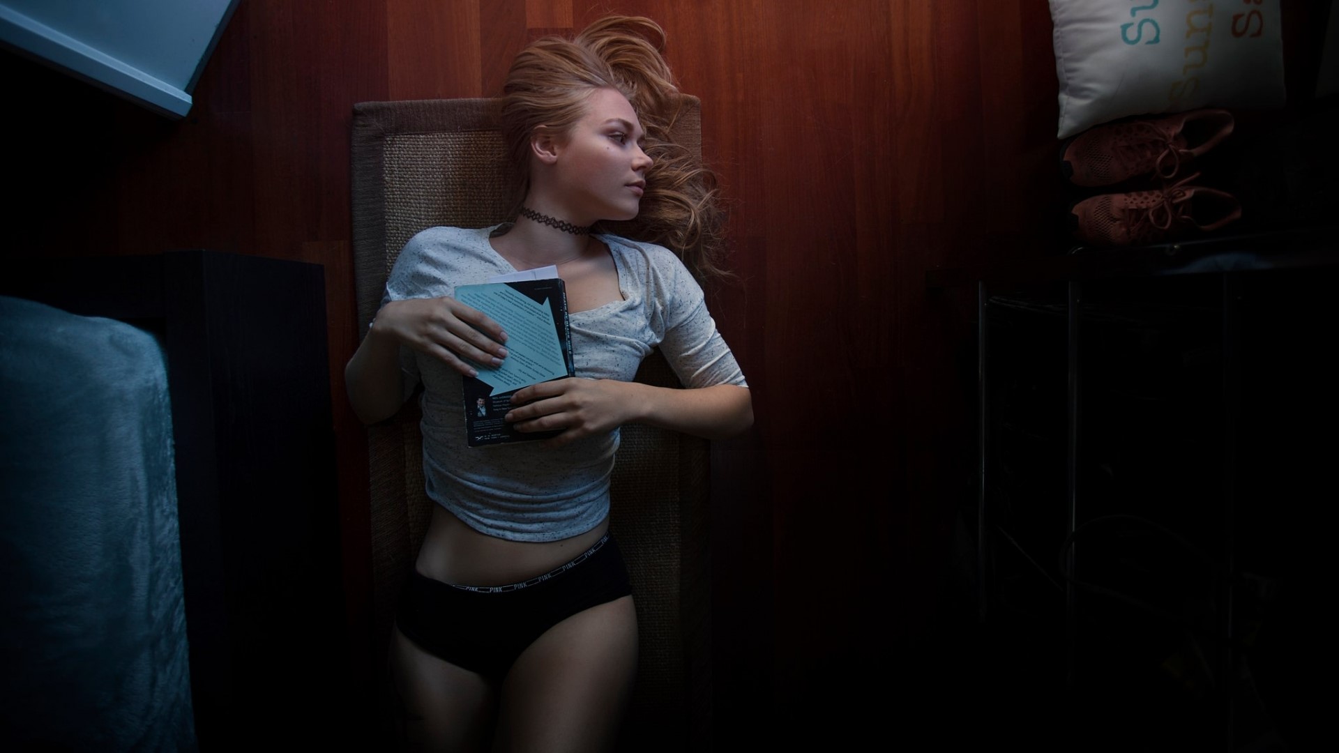 Girl lying on floor holding a book HD Wallpaper