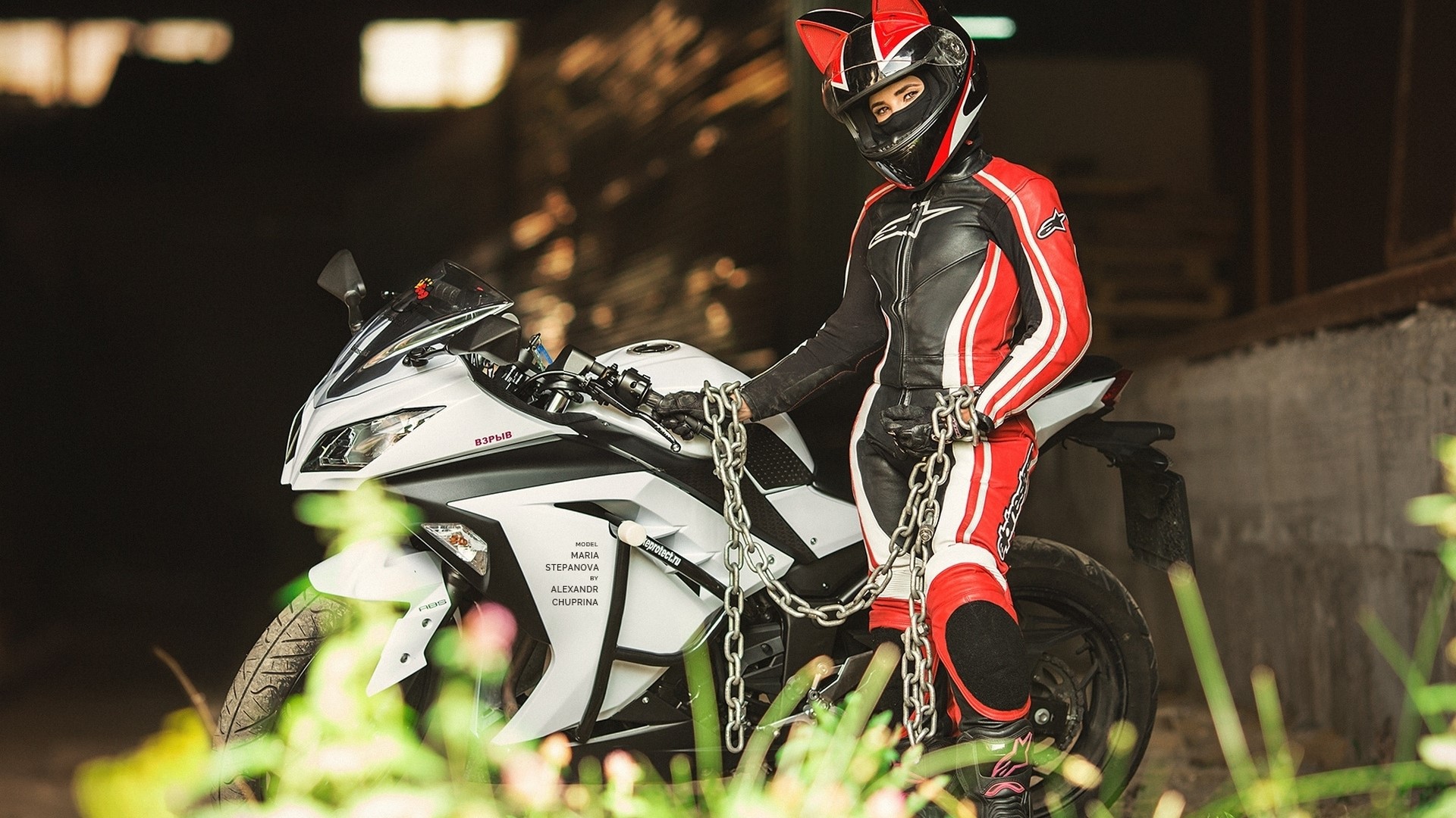 Woman in cat-ear helmet and motorcycle gear with chains HD Wallpaper