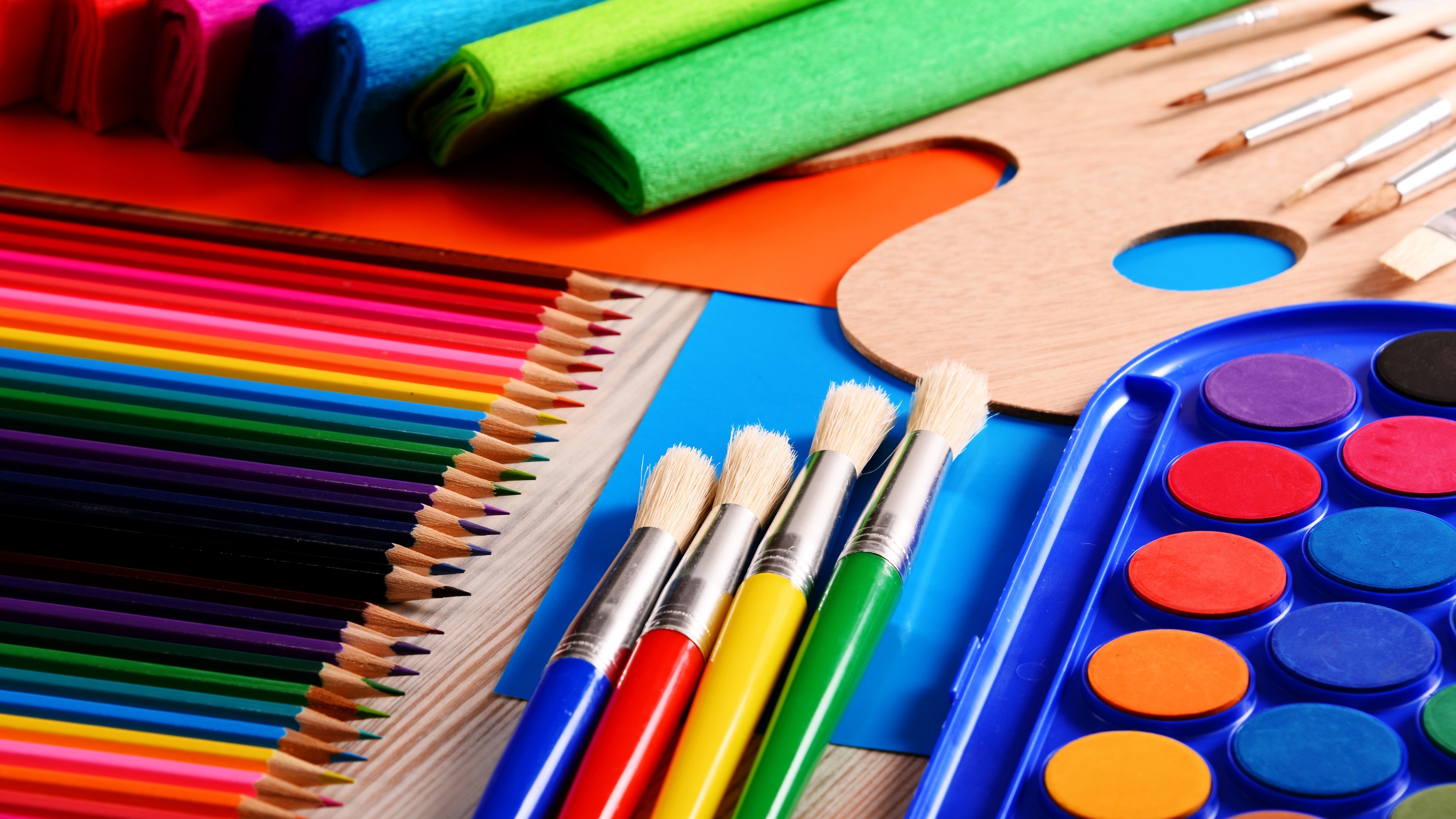 Art supplies: colored pencils, paintbrushes, watercolor palette, paper HD Wallpaper