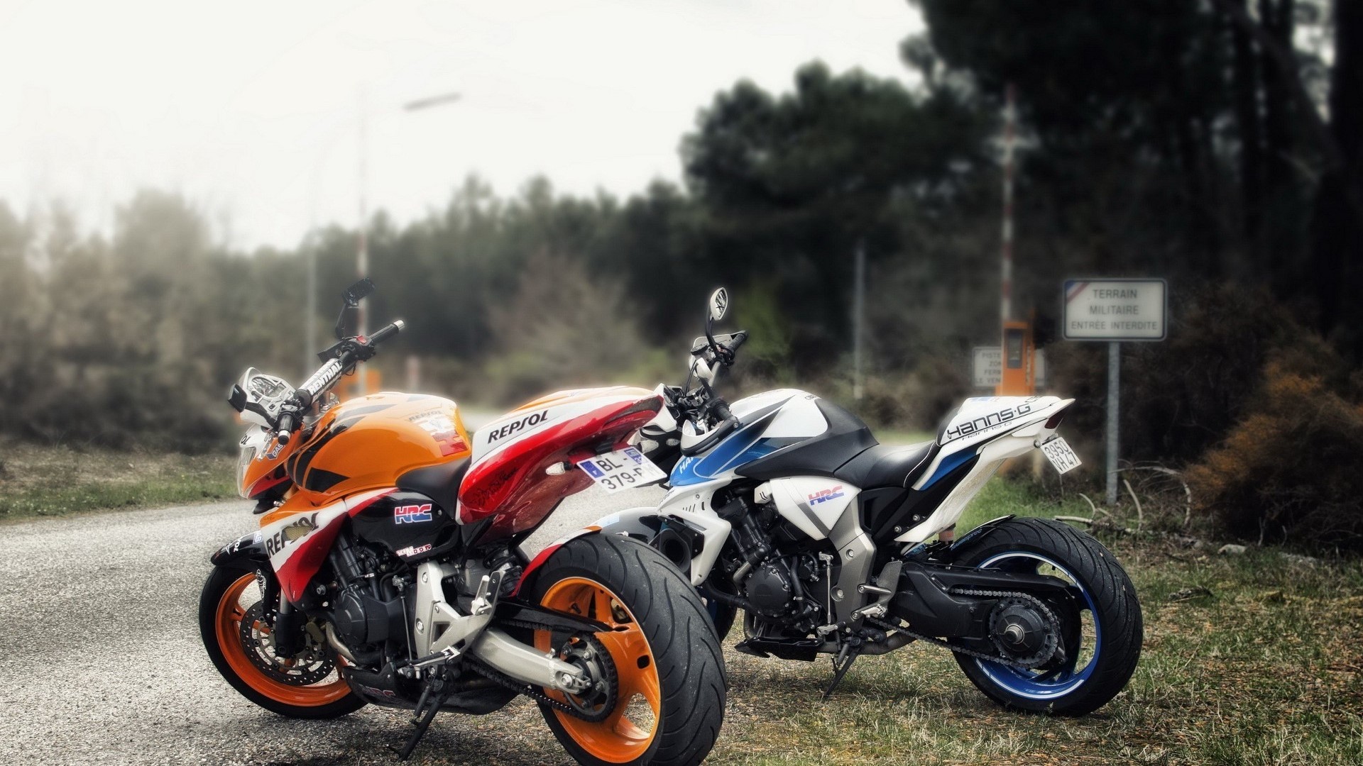Two Honda motorcycles parked on a road HD Wallpaper