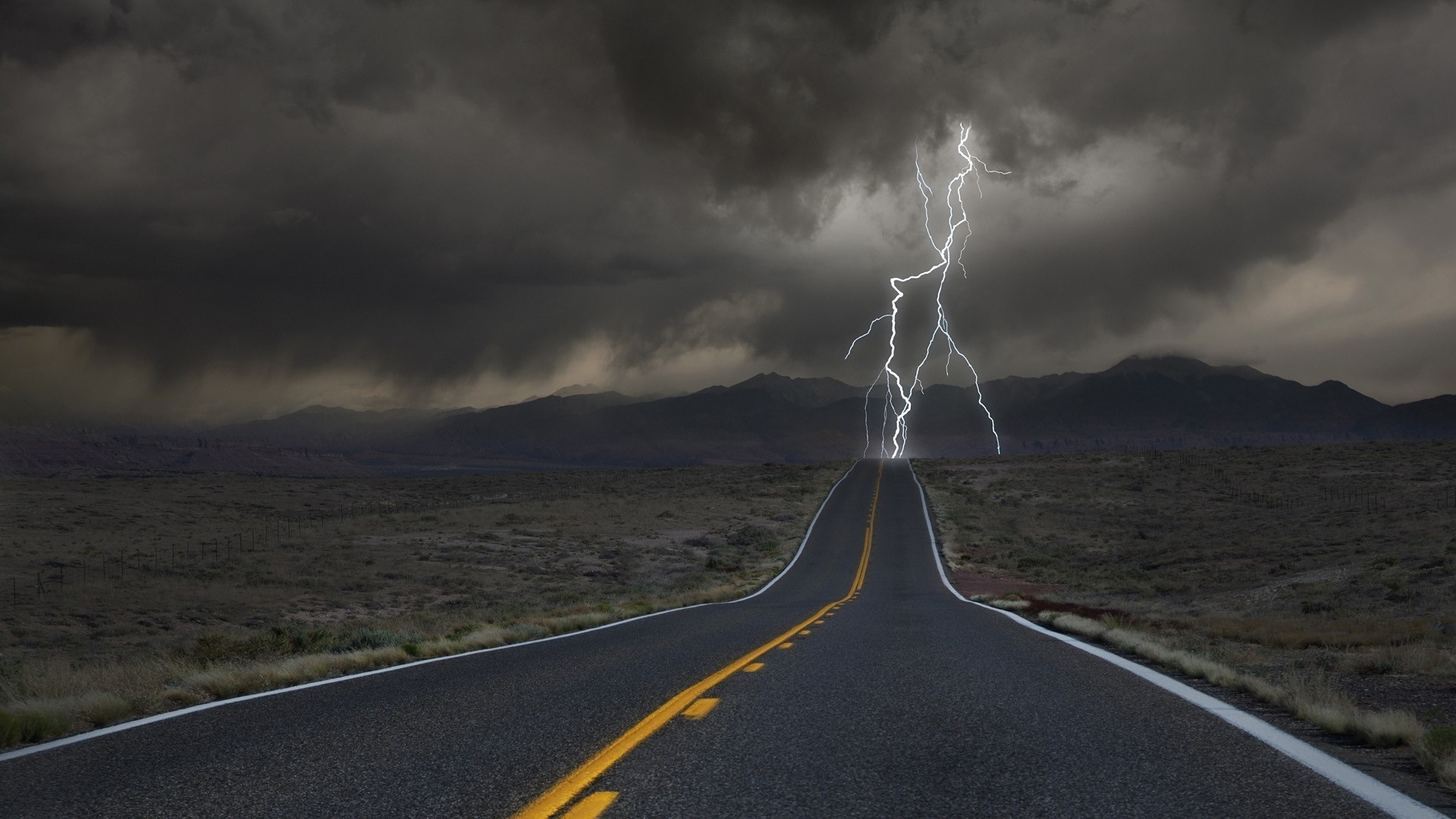 Lightning strikes a highway in a stormy landscape HD Wallpaper